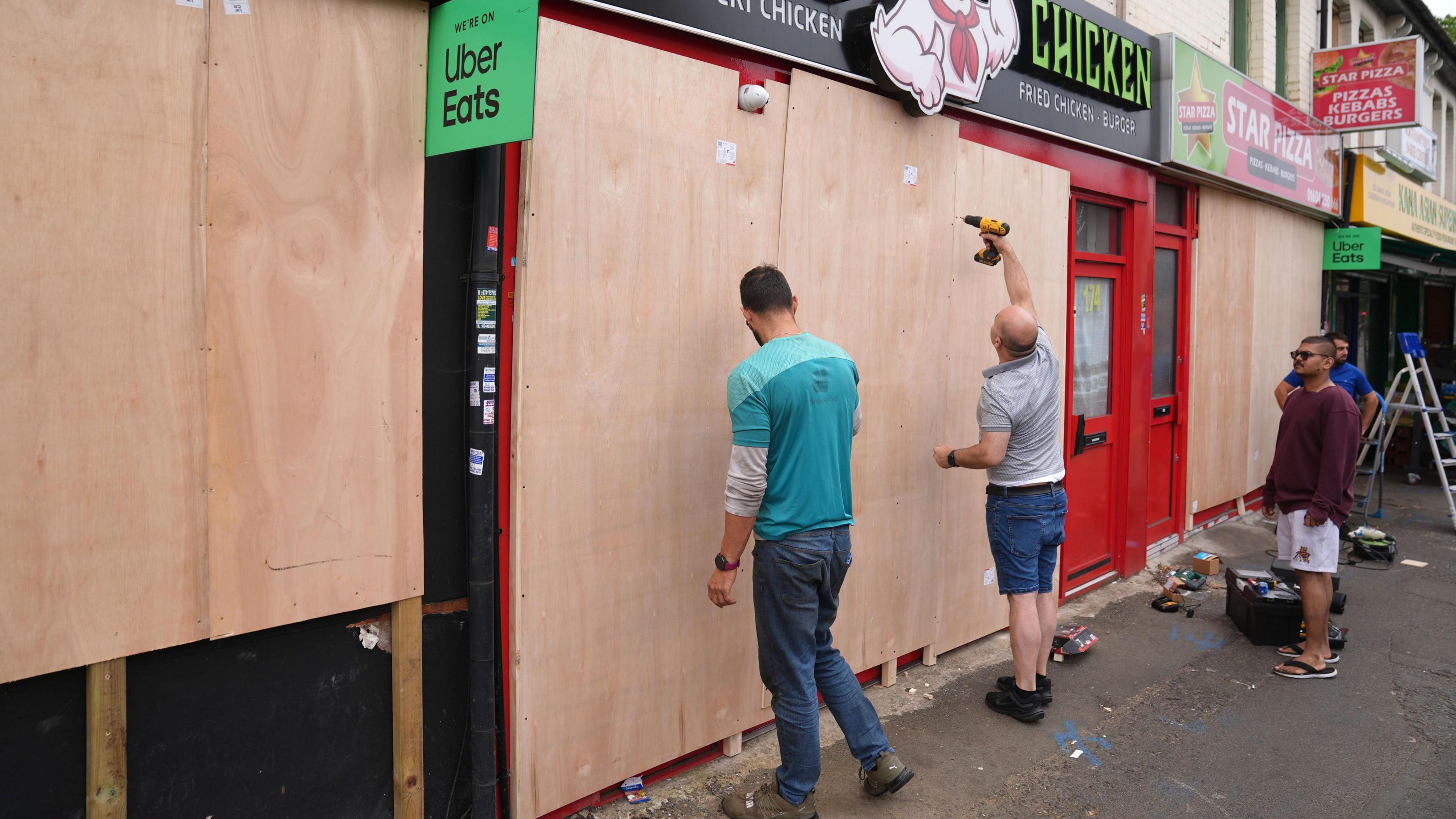 People board up shop windows in Northampton