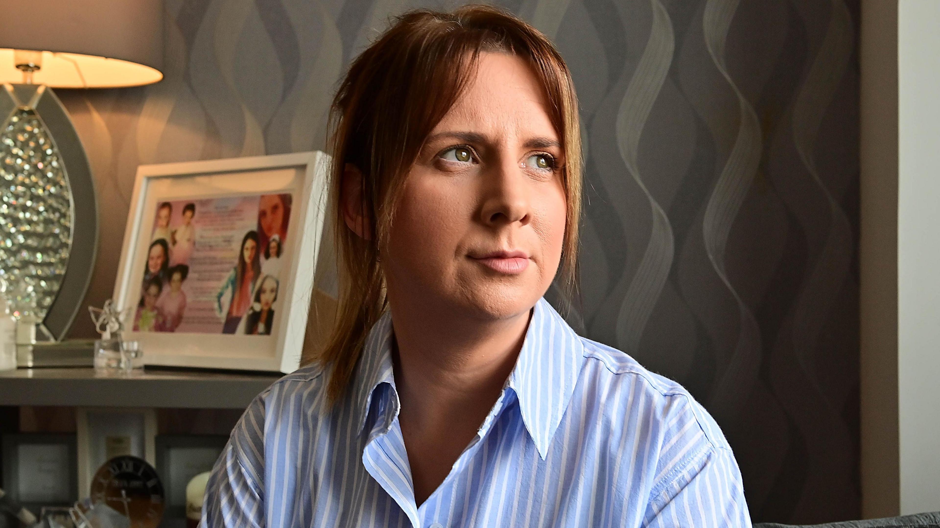 Deborah Hanna in blue striped shirt with brown hair