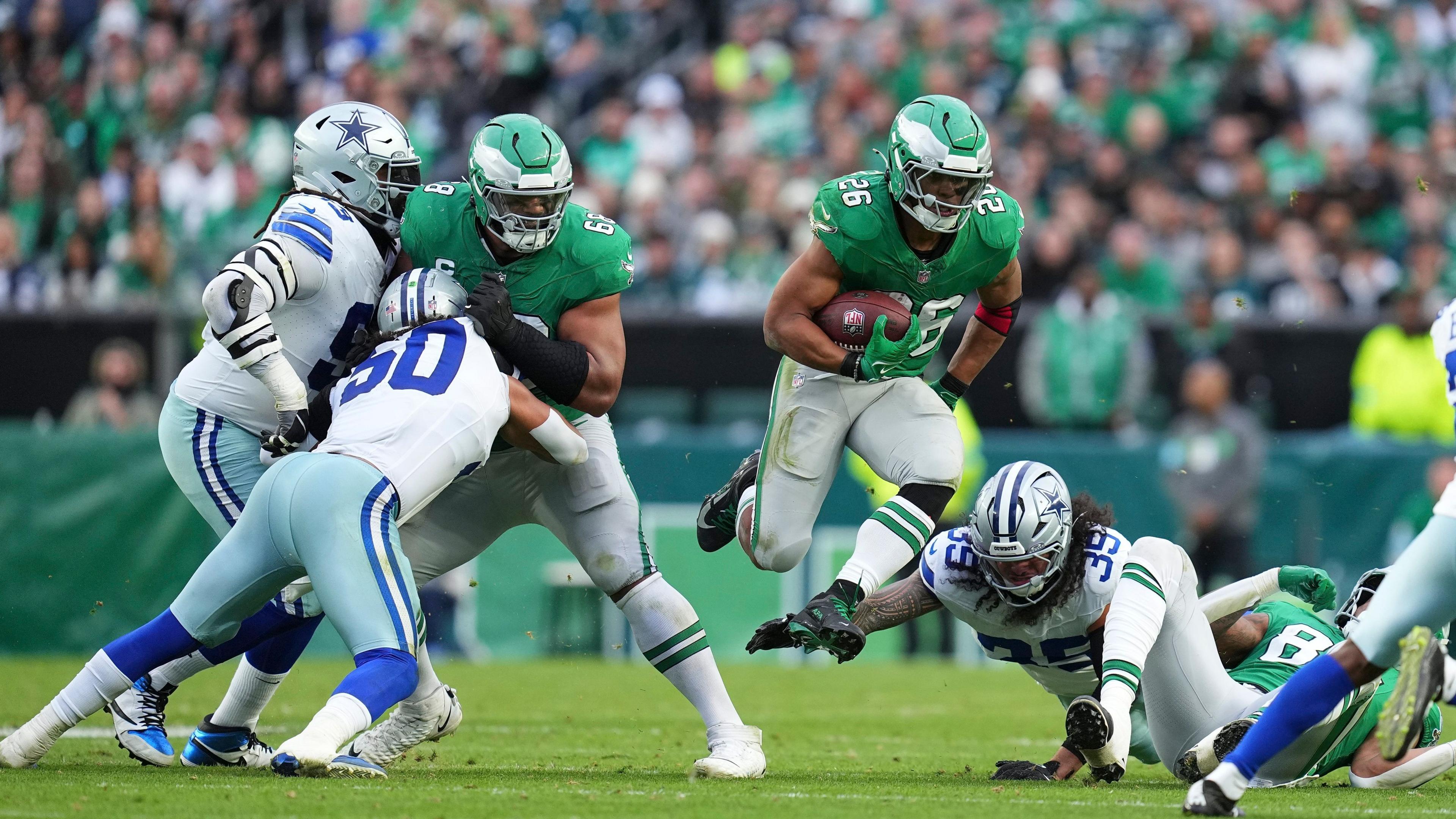 Eagles running back Saquon Barkley evades Dallas Cowboys defenders