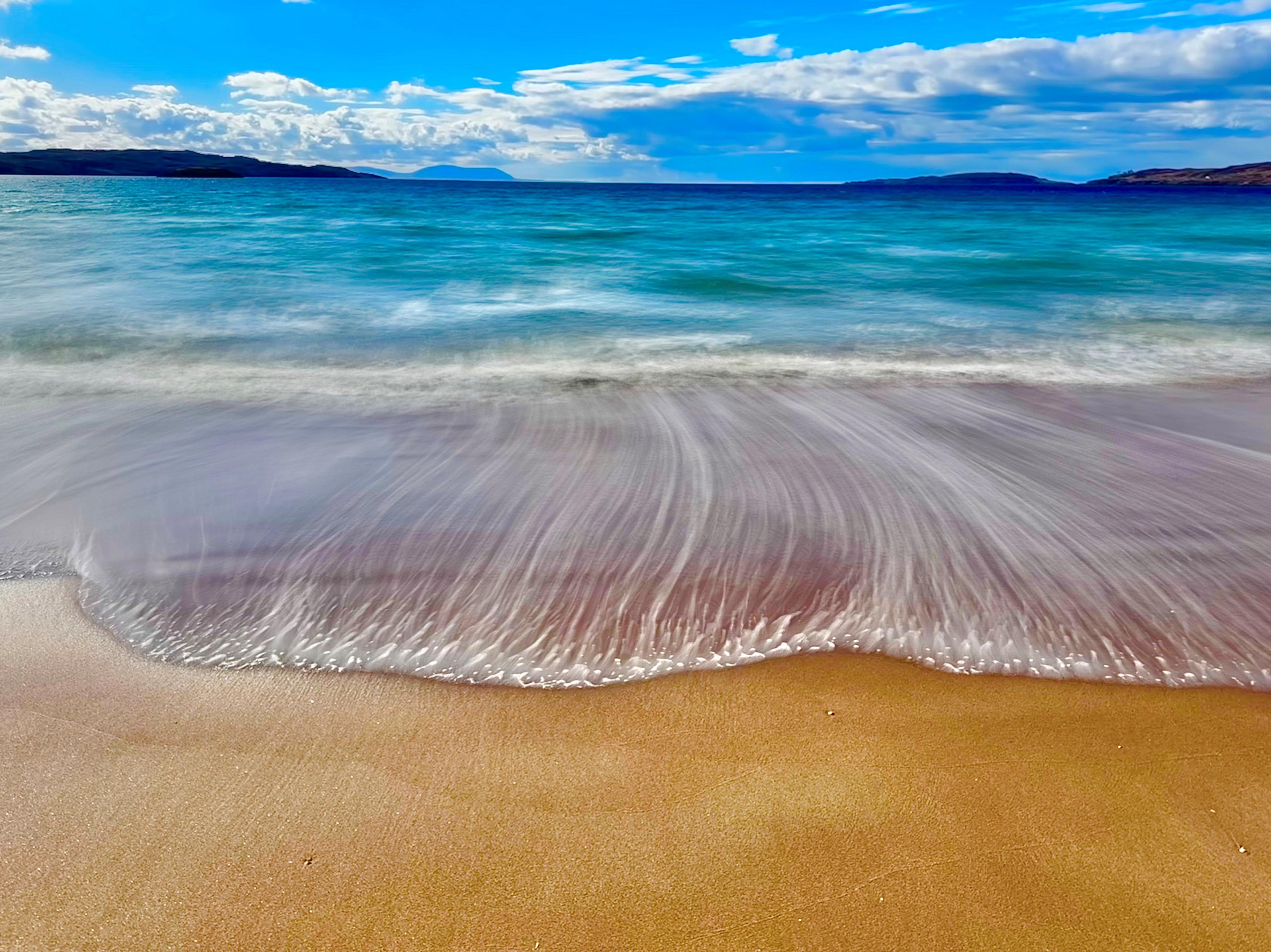 Landscape of a beach - waves washing up on the sand