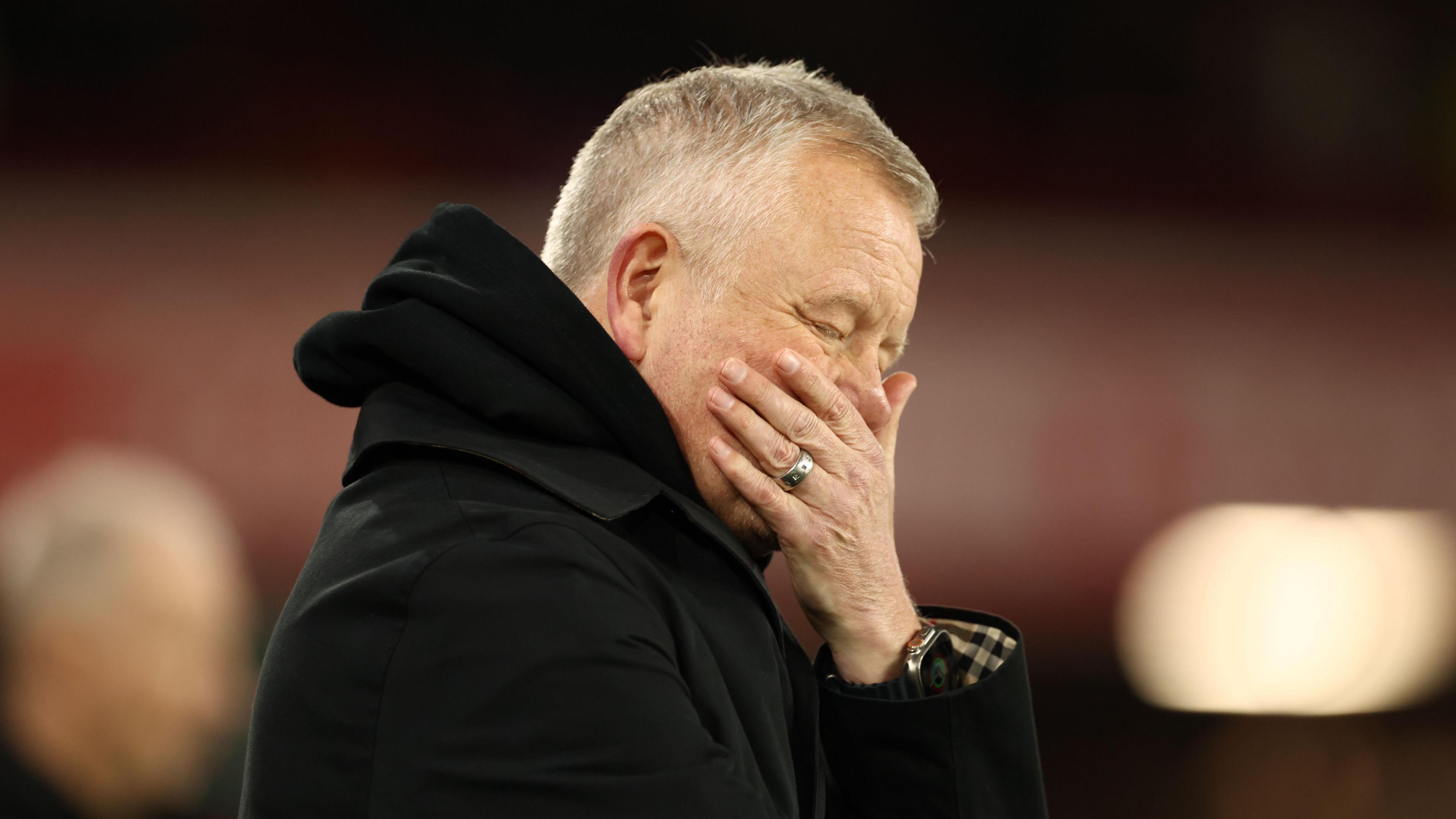 Chris Wilder covers his face during the defeat to Leeds