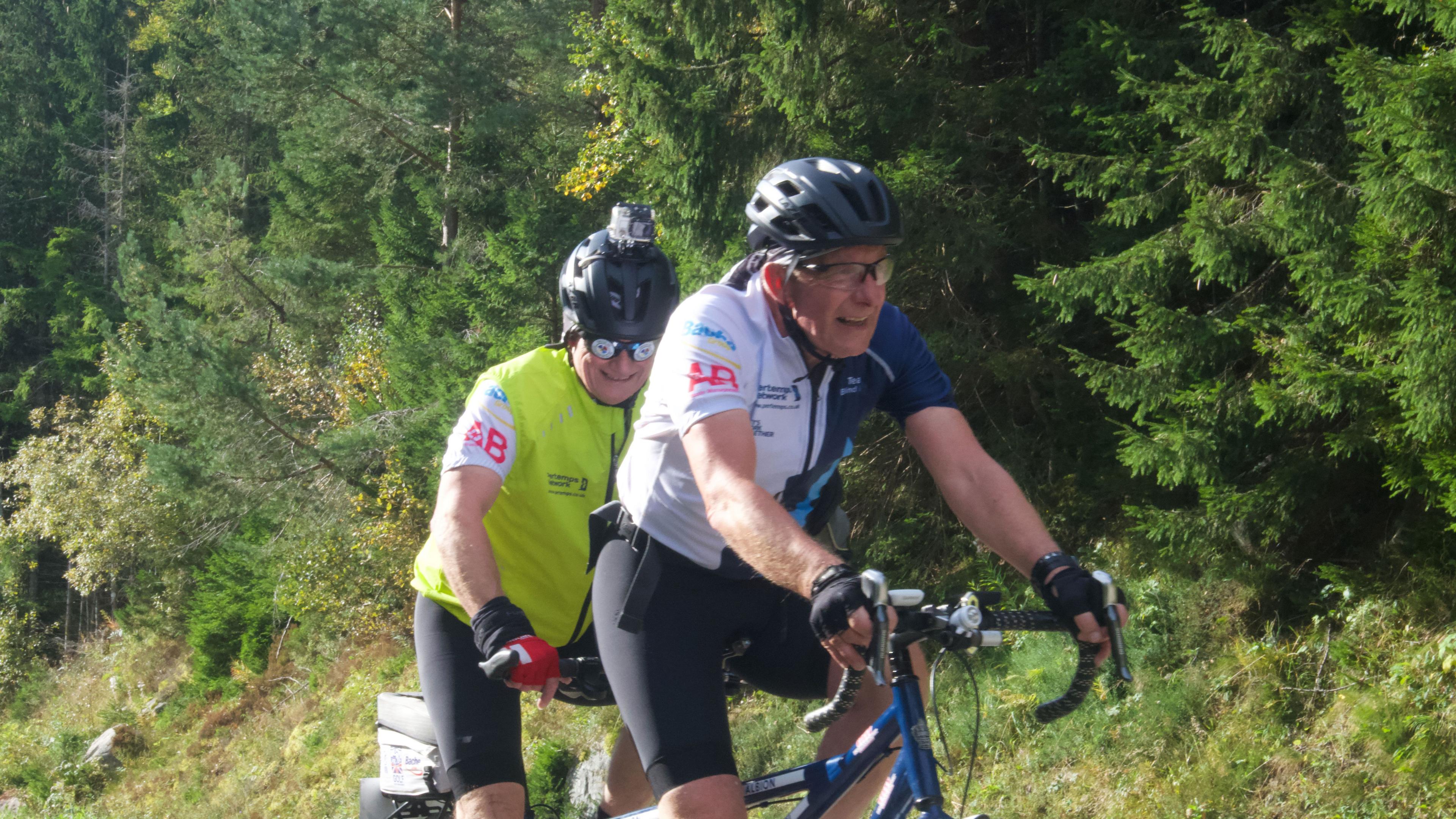 Two men riding a tandem bicycle