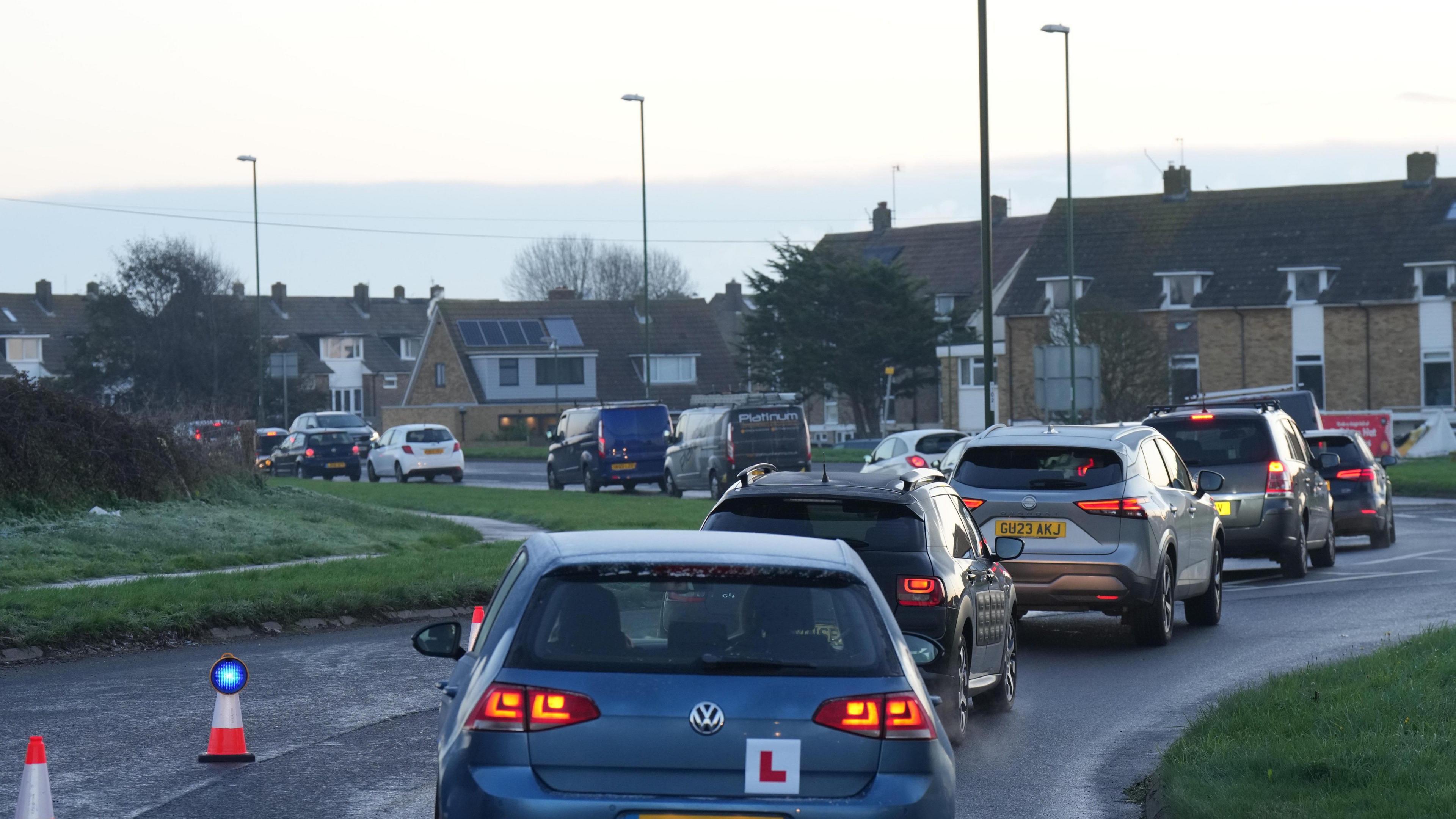 A queue of cars lined up at the scene of the crash at Saltings roundabout