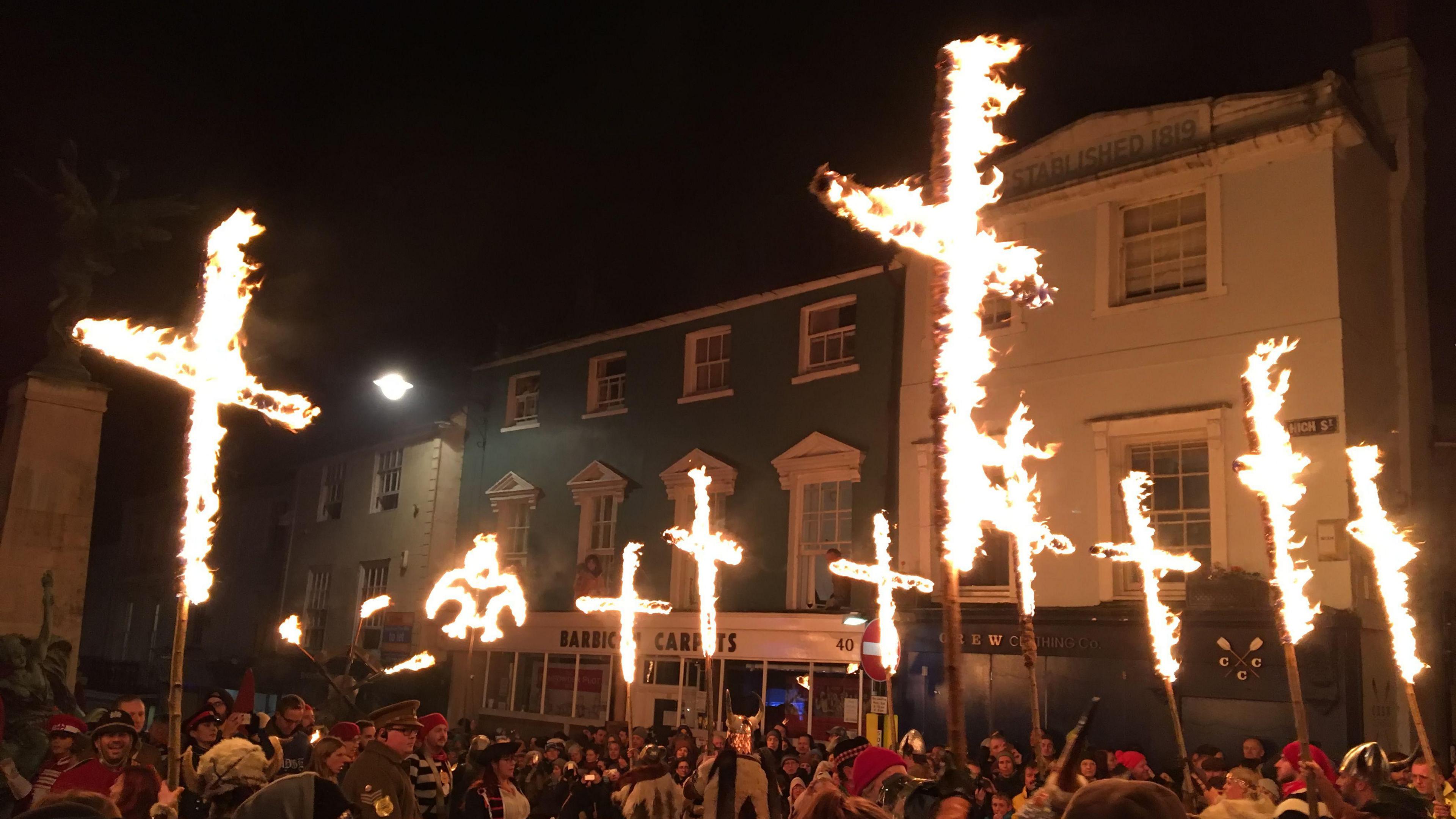 Burning crosses being carried by people taking part in the Lewes Bonfire procession in 2016.
