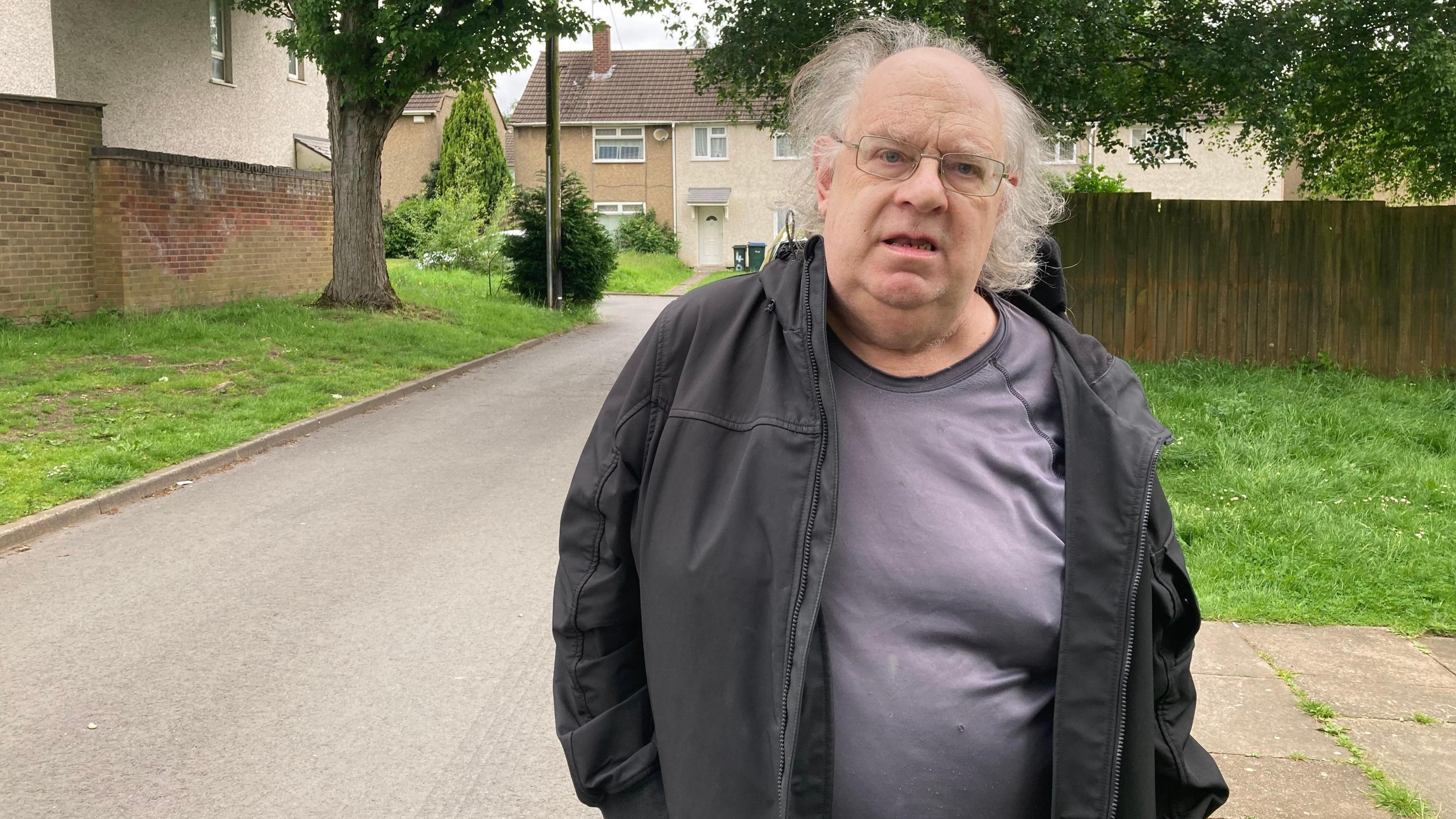 Chris Reynolds outside his home