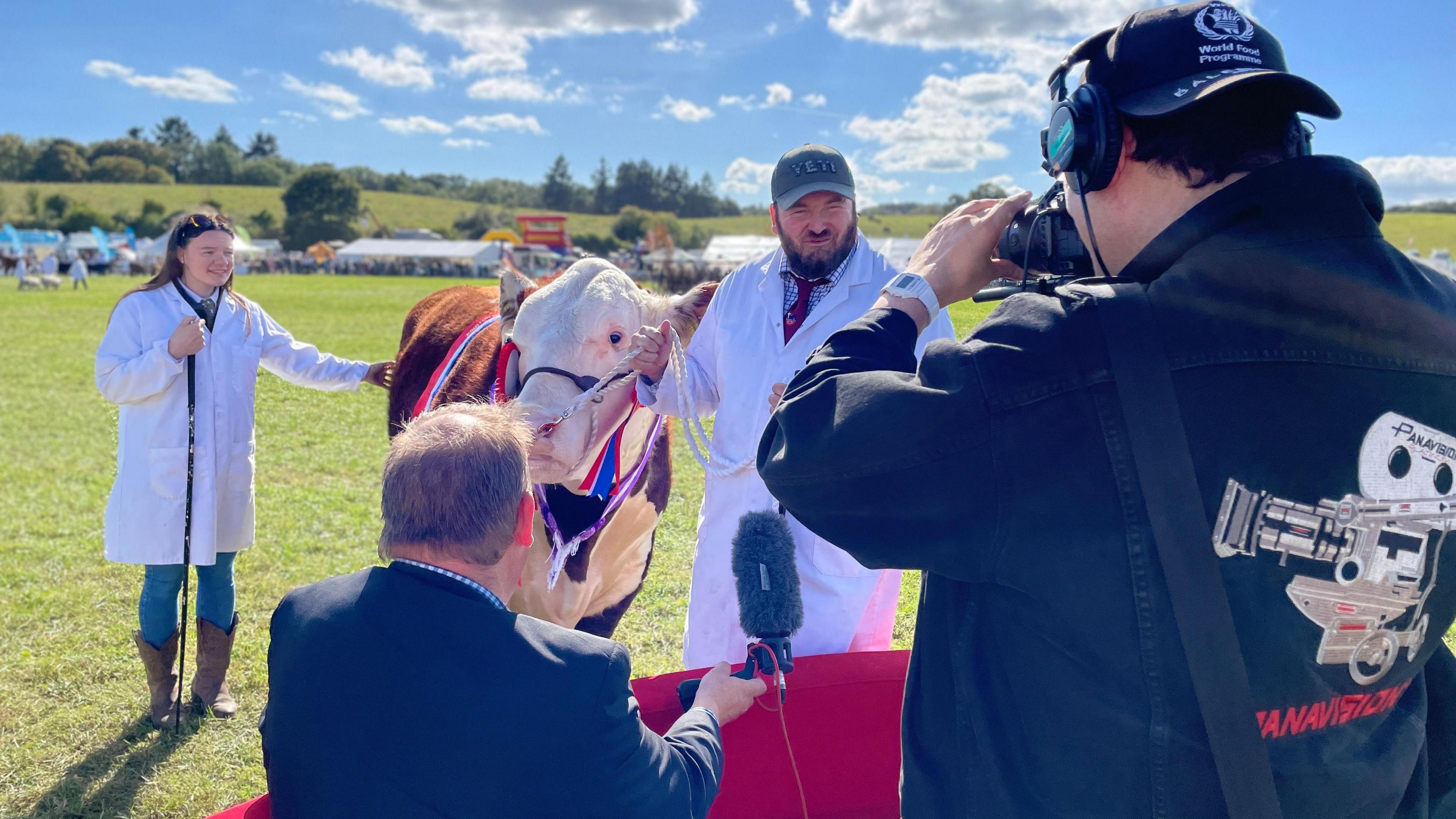 The owner of a prize-winning bull at the Kington Show in Herefordshire is interviewed by reporter Ben Sidwell who is sitting on the red sofa 