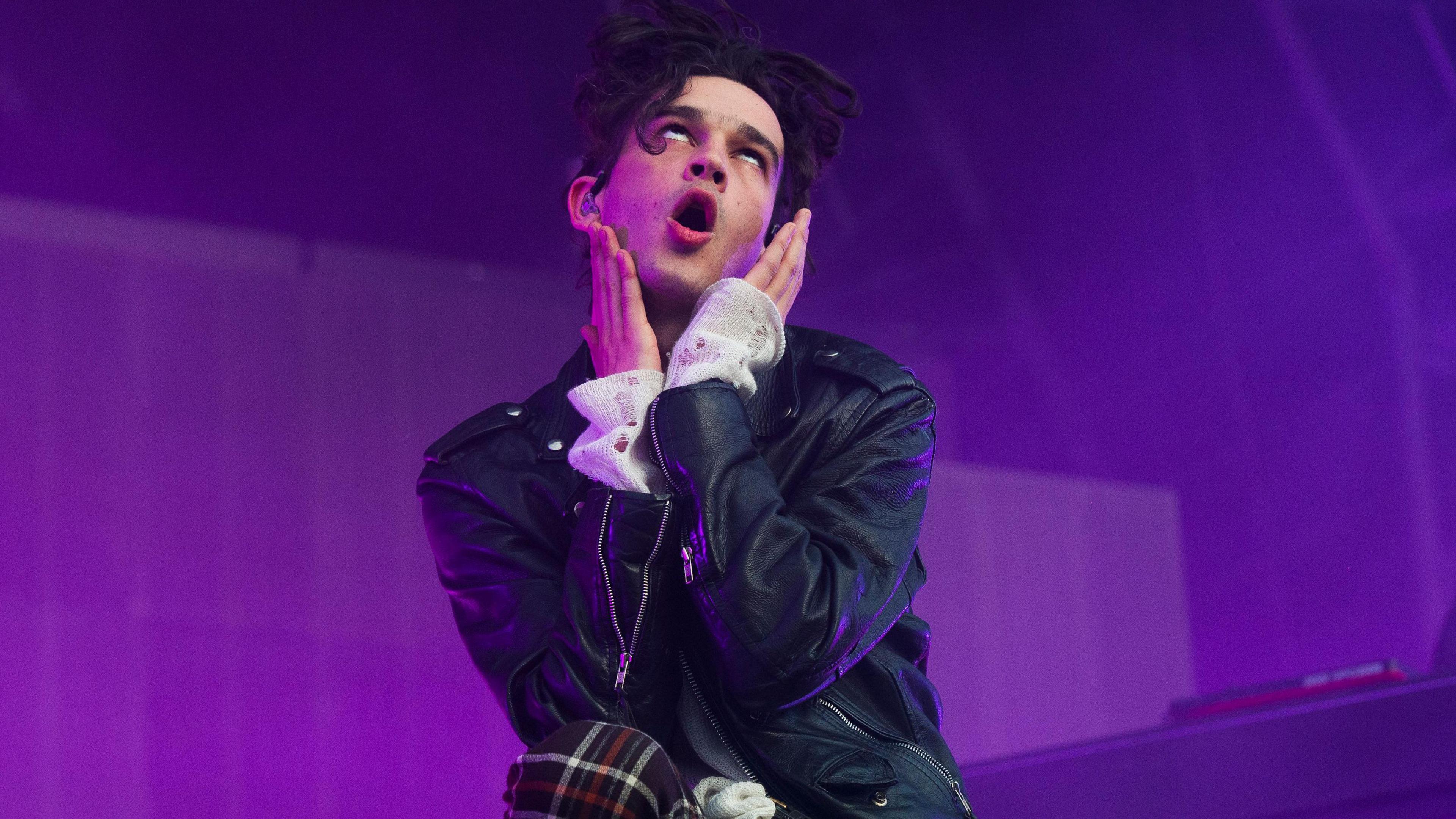 Matt Healey from the 1975 performing on stage. 