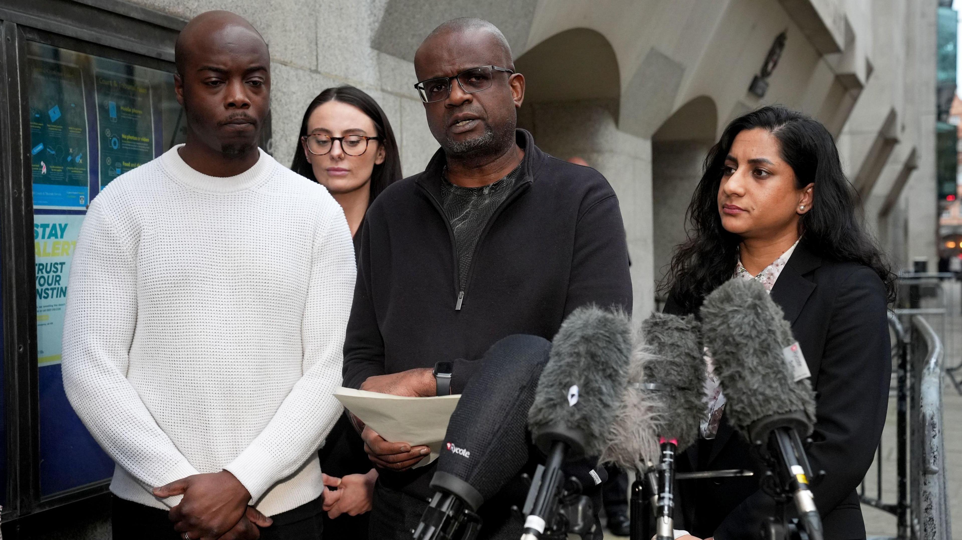 Michael Andam (centre), the father of Elianne Andam is accompanied by family members as he speaks to the media outside the Old Bailey