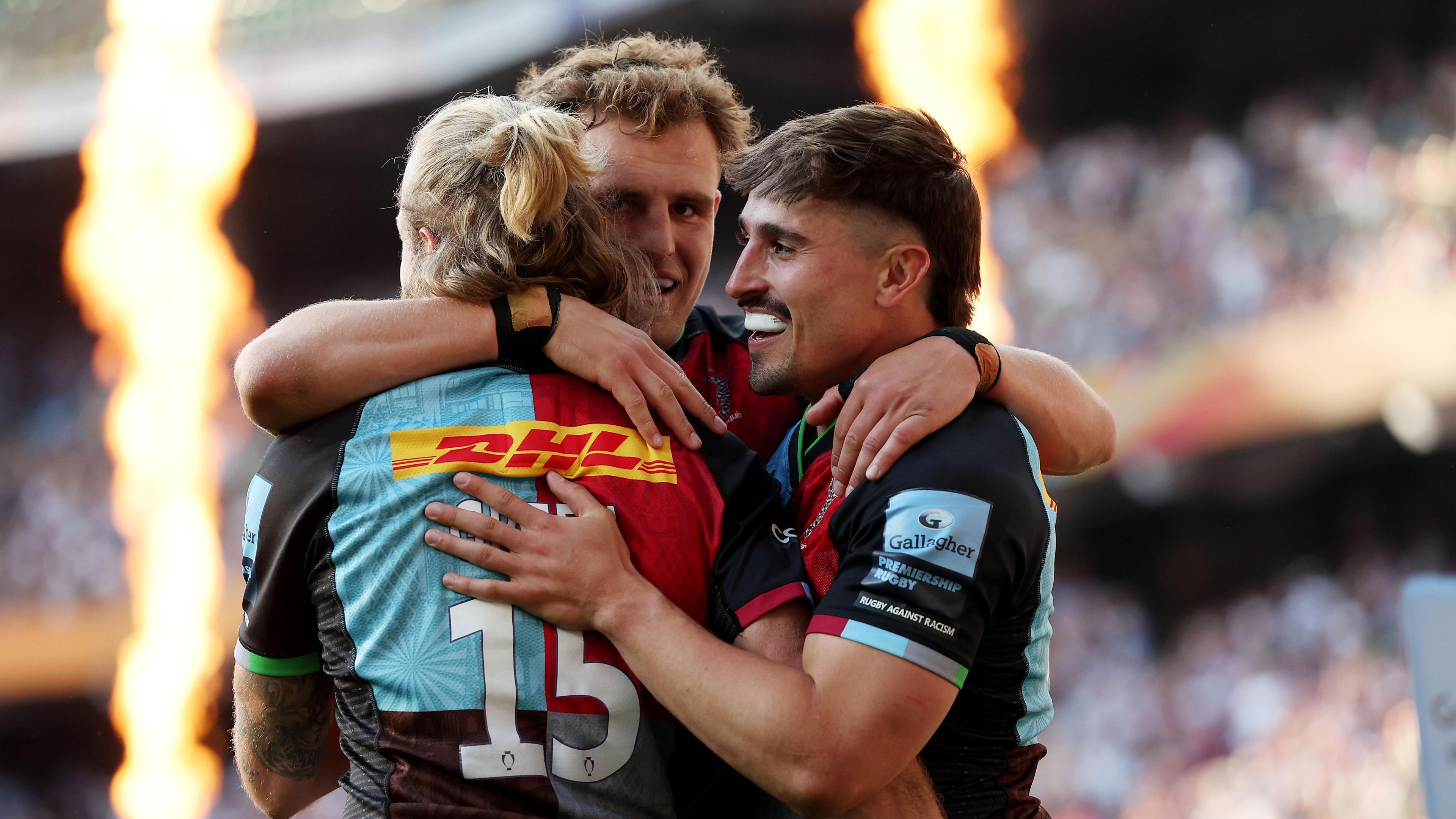 Cadan Murley (right) is congratulated by Harlequins team-mates Tyrone Green and Oscar Beard (centre) for one of his tries at Allianz Stadium