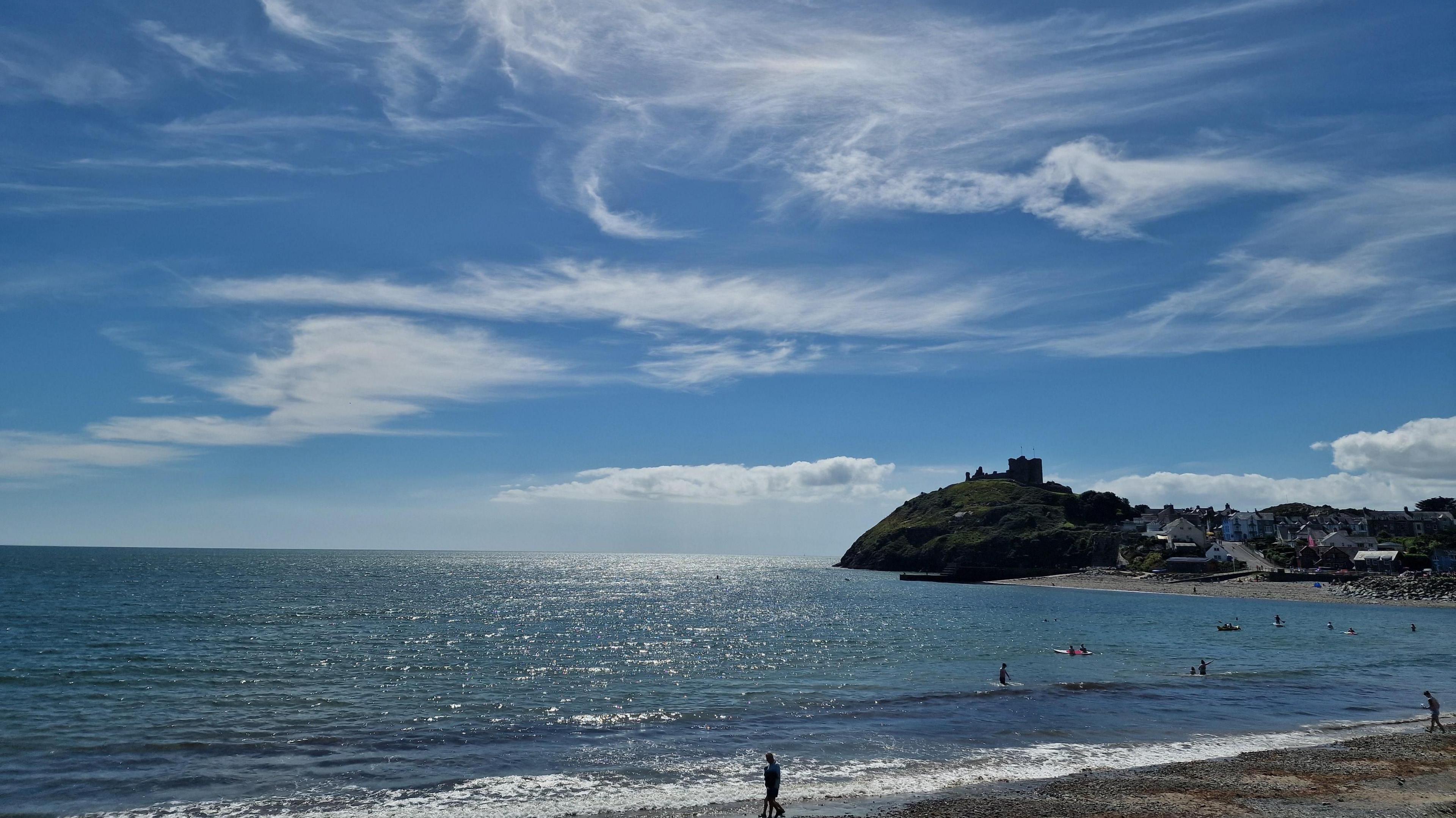 Blue sky and high cloud over a beach in Gwynedd