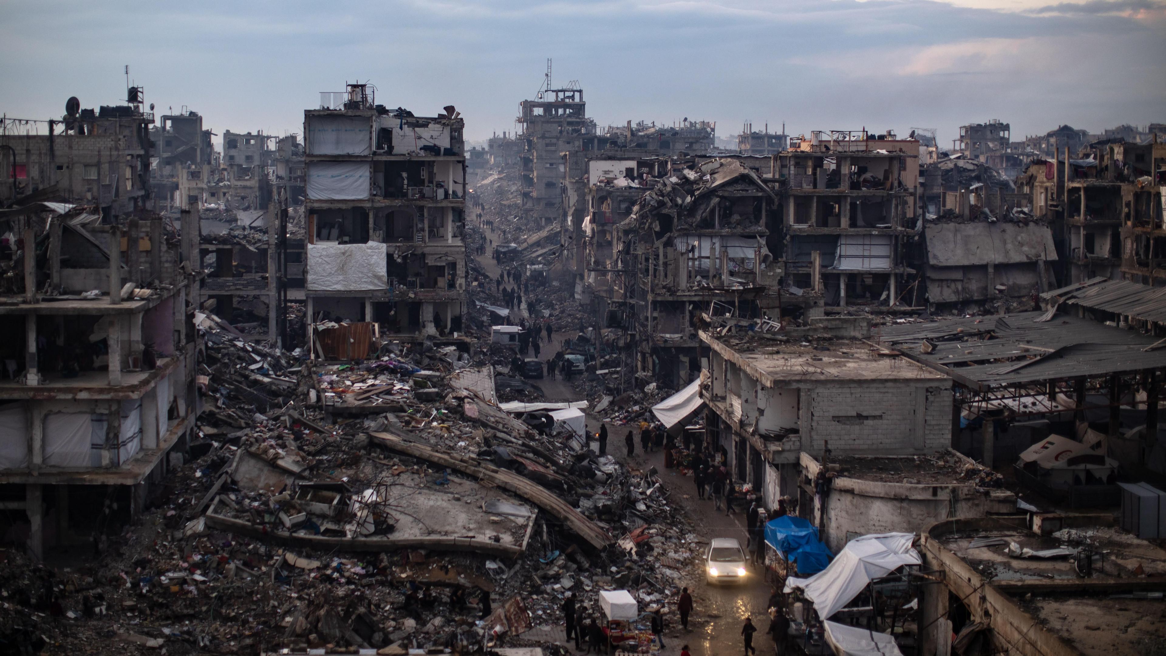 Palestinians walk past destroyed buildings in the Jabalia camp, north of Gaza City.