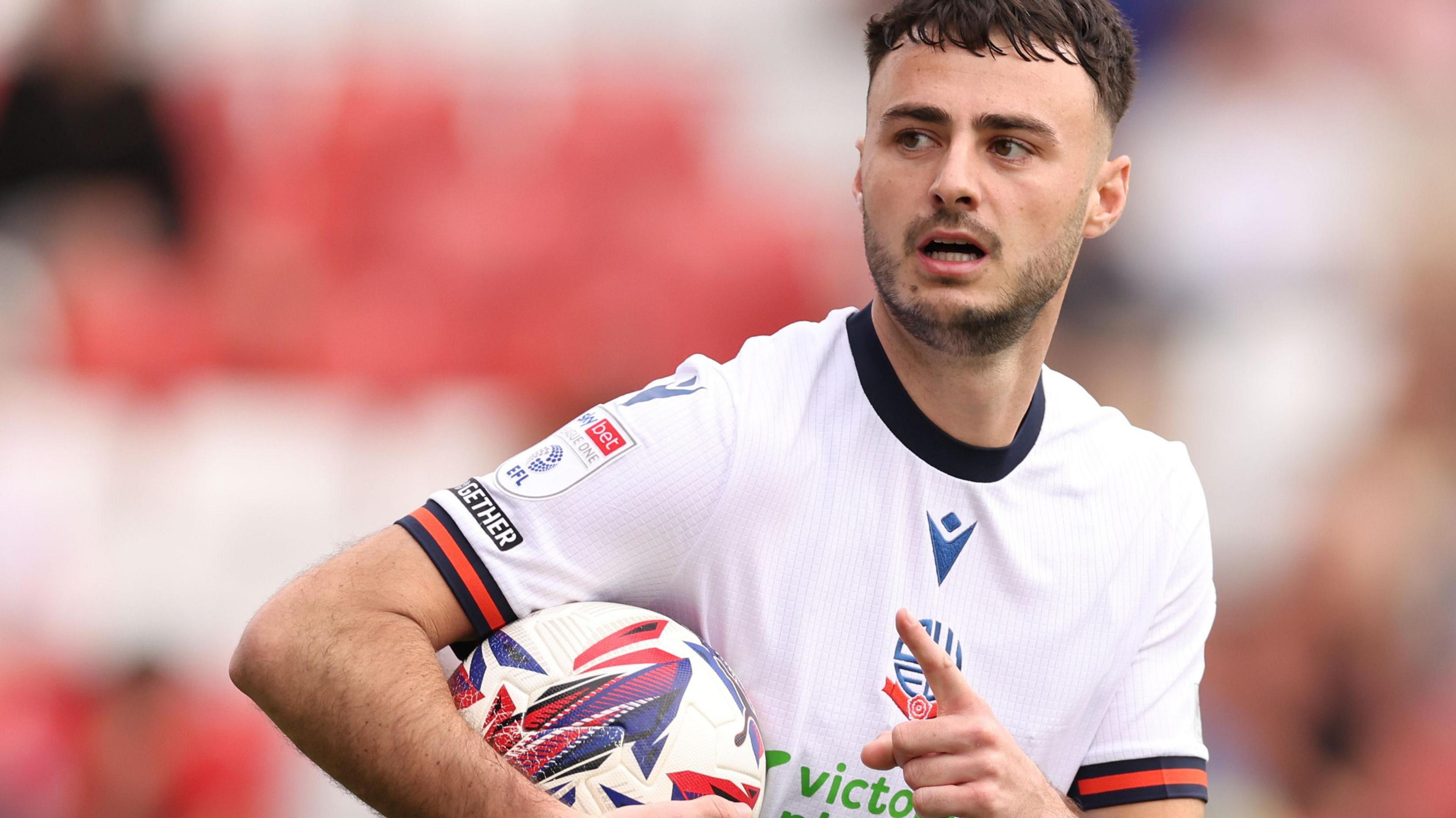 Aaron Collins celebrates a goal for Bolton