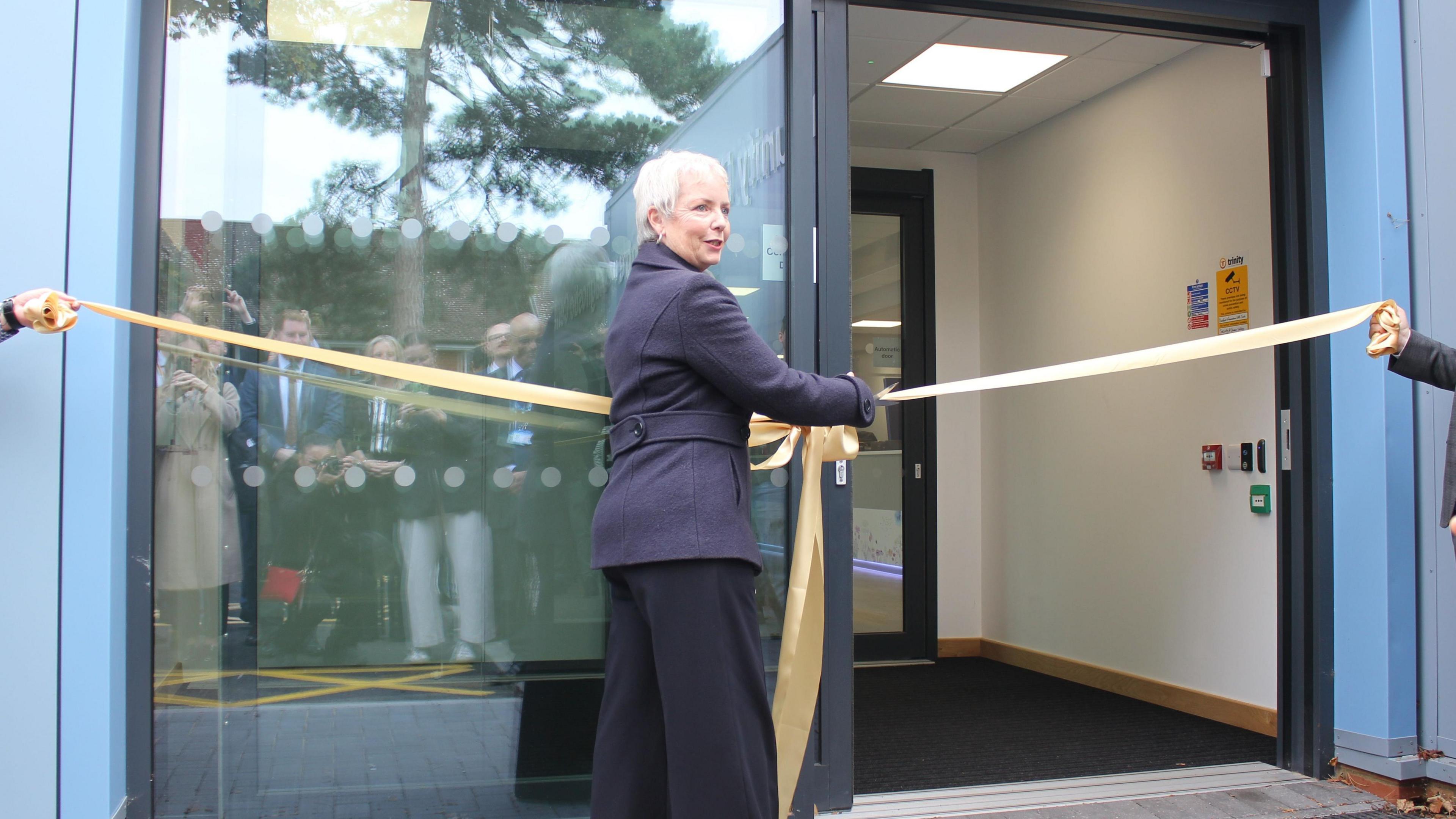 An image of health minister Karin Smyth opening the new community diagnostic centre at the Livingstone Community Hospital in Dartford, Kent. Karin is cutting a gold ribbon.