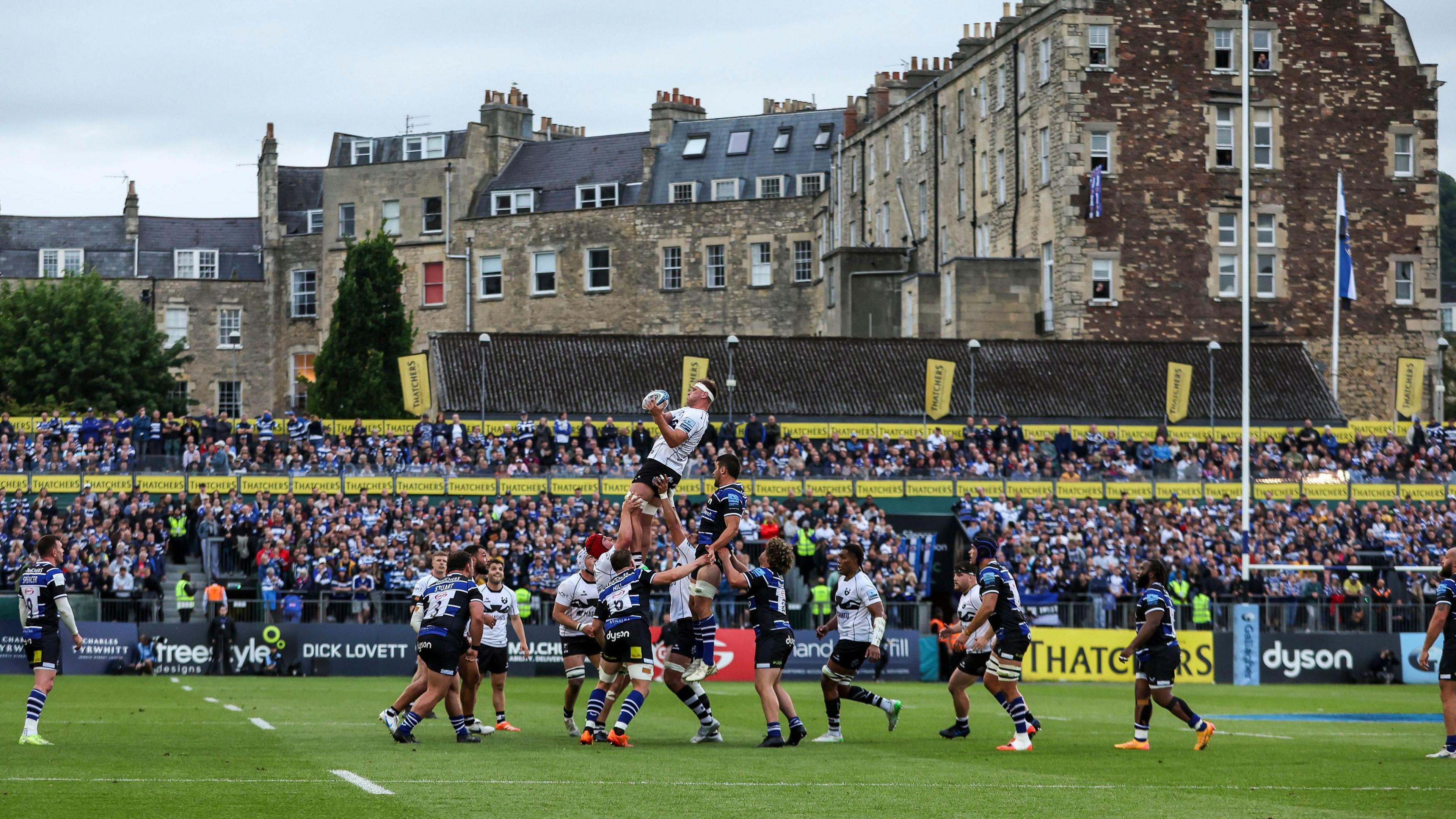 Players from Bristol and Bath contest a lineout at the Rec during their Premiership semi-final match. In the background some of Bath's Georgian houses are visible