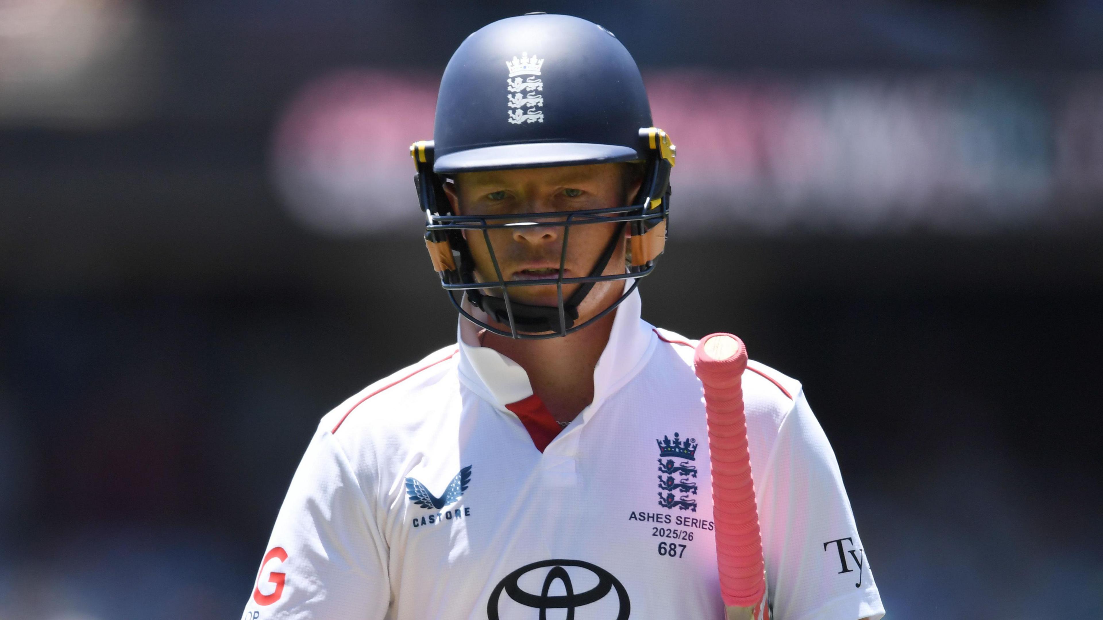 Ollie Pope looks dejected, with his bat under his arm