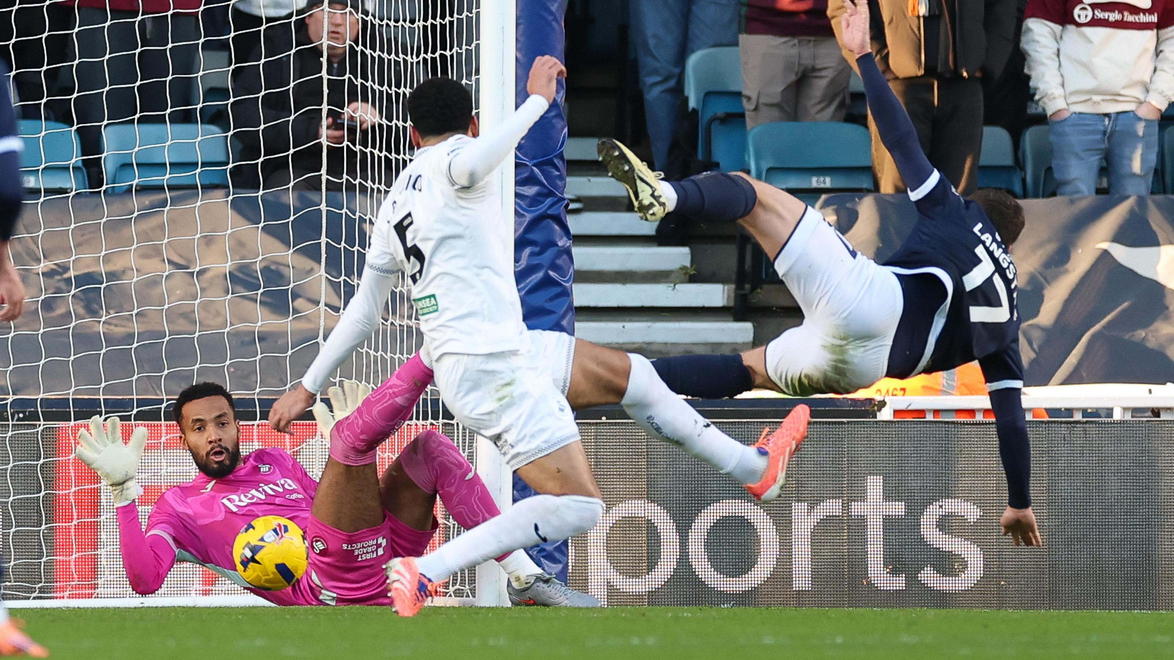 Lawrence Vigouroux saves from Macaulay Langstaff at Millwall 