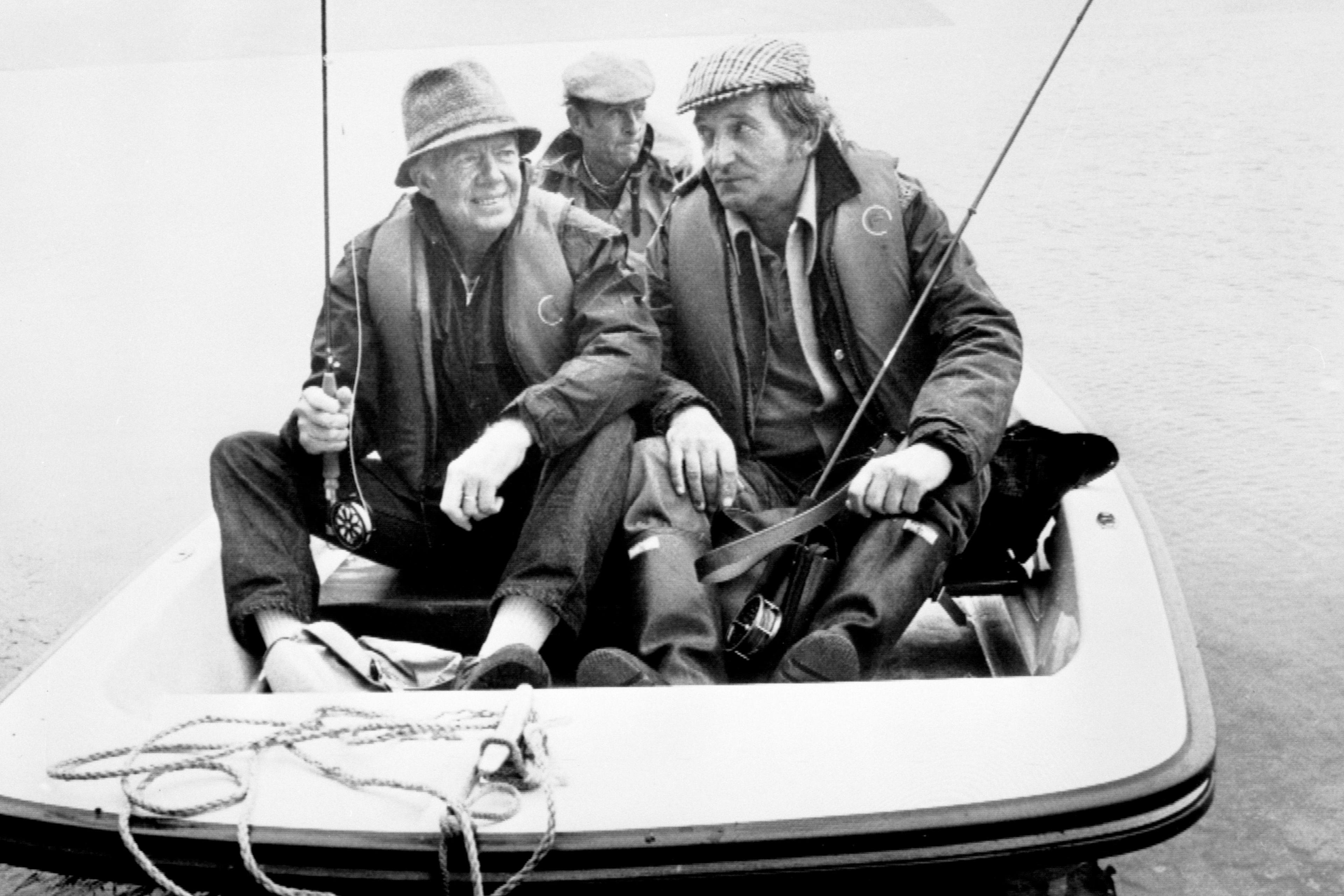 A black and white image of former US President Jimmy Carter (left) with Moc Morgan on a boat on Clywedog Reservoir