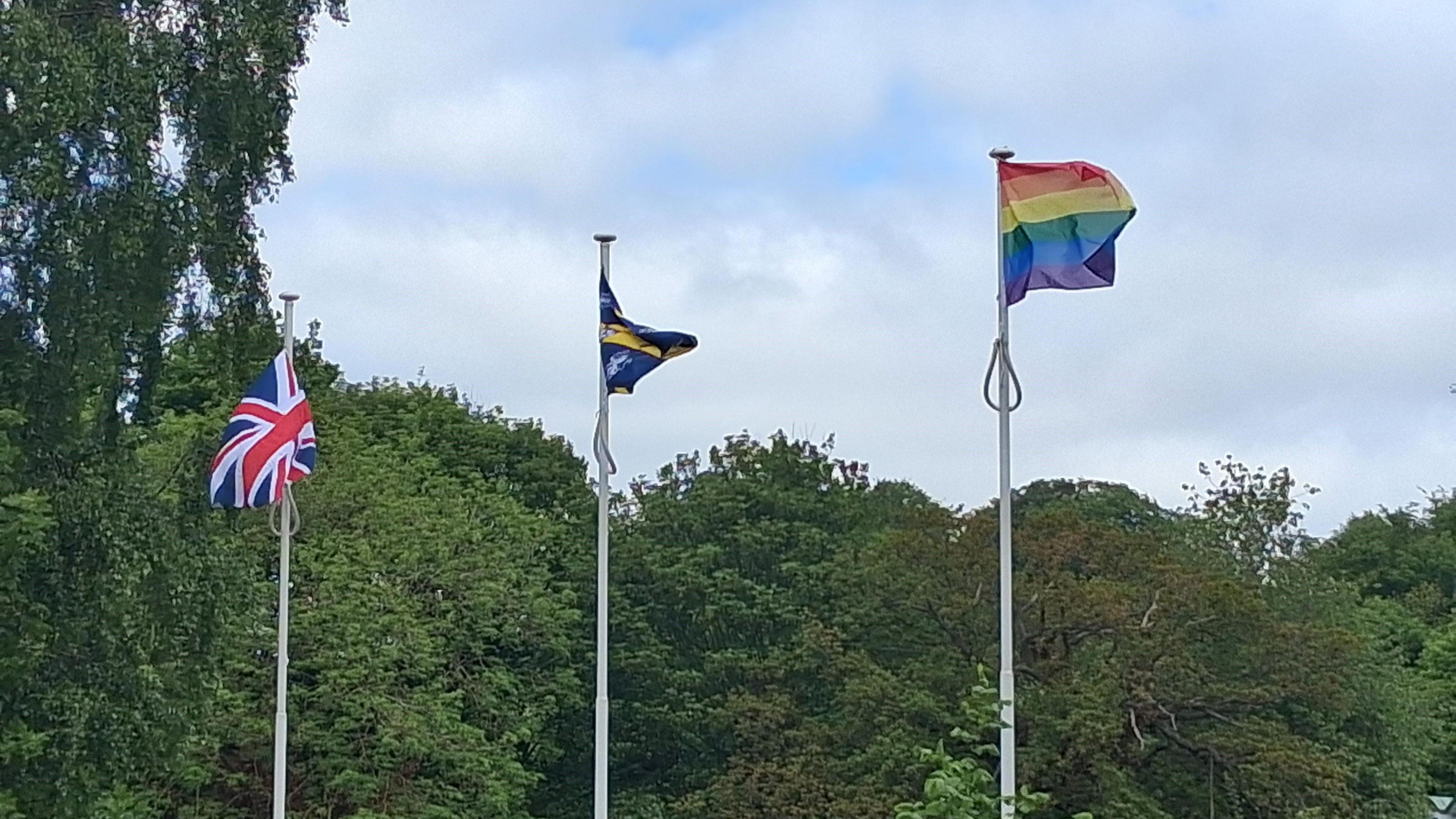 A union jack, flag of County Durham and a Pride rainbow flag all flying.