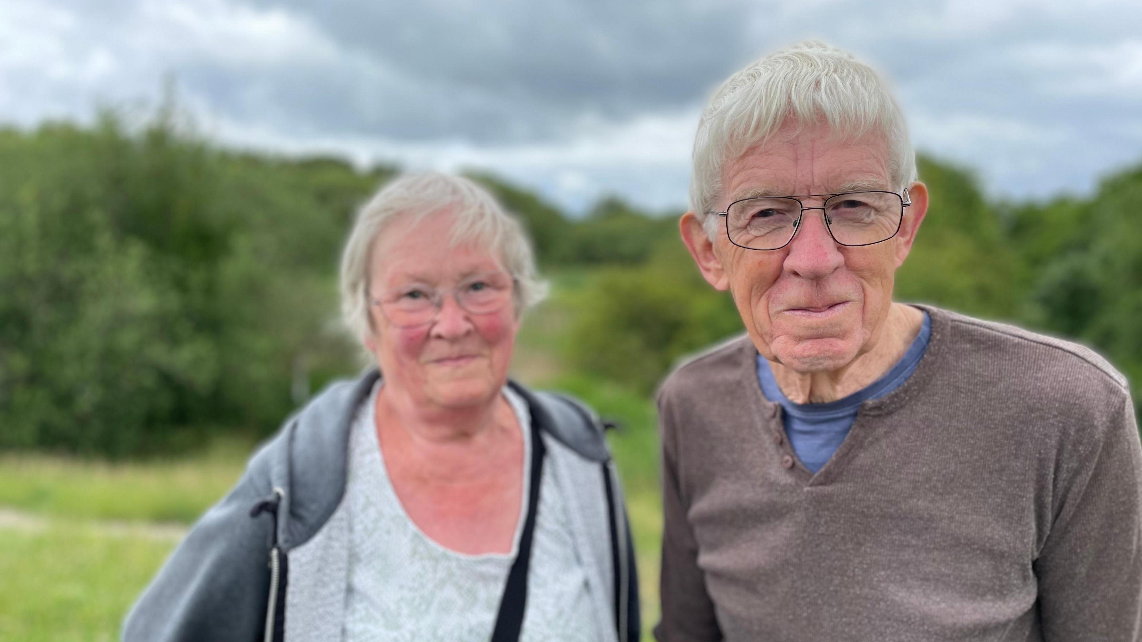 Two siblings in their 70s stood in the nature reserve