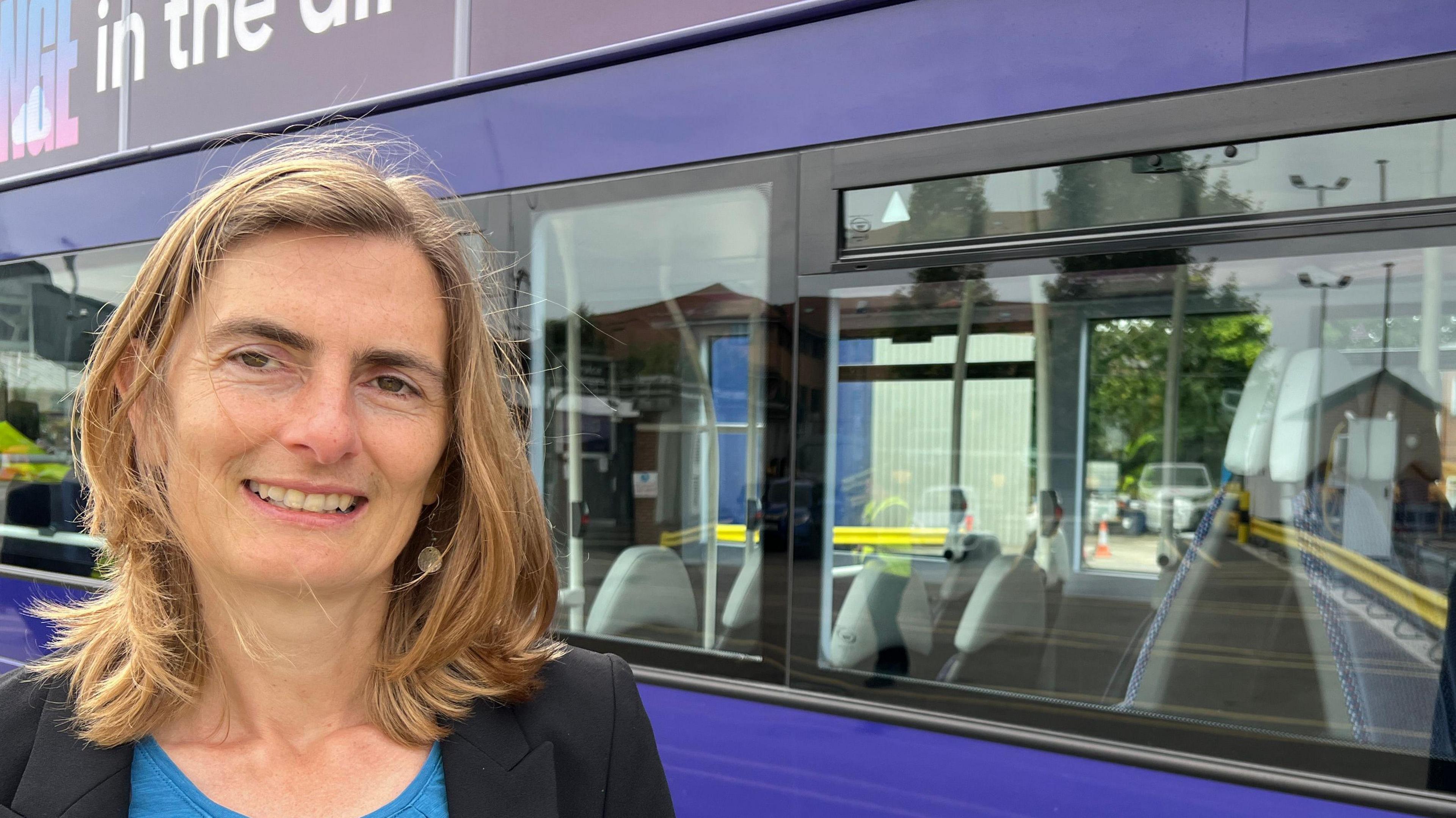 Kate Ravilious - City of York Council's executive member for transport - in front of a fully electric First York bus.