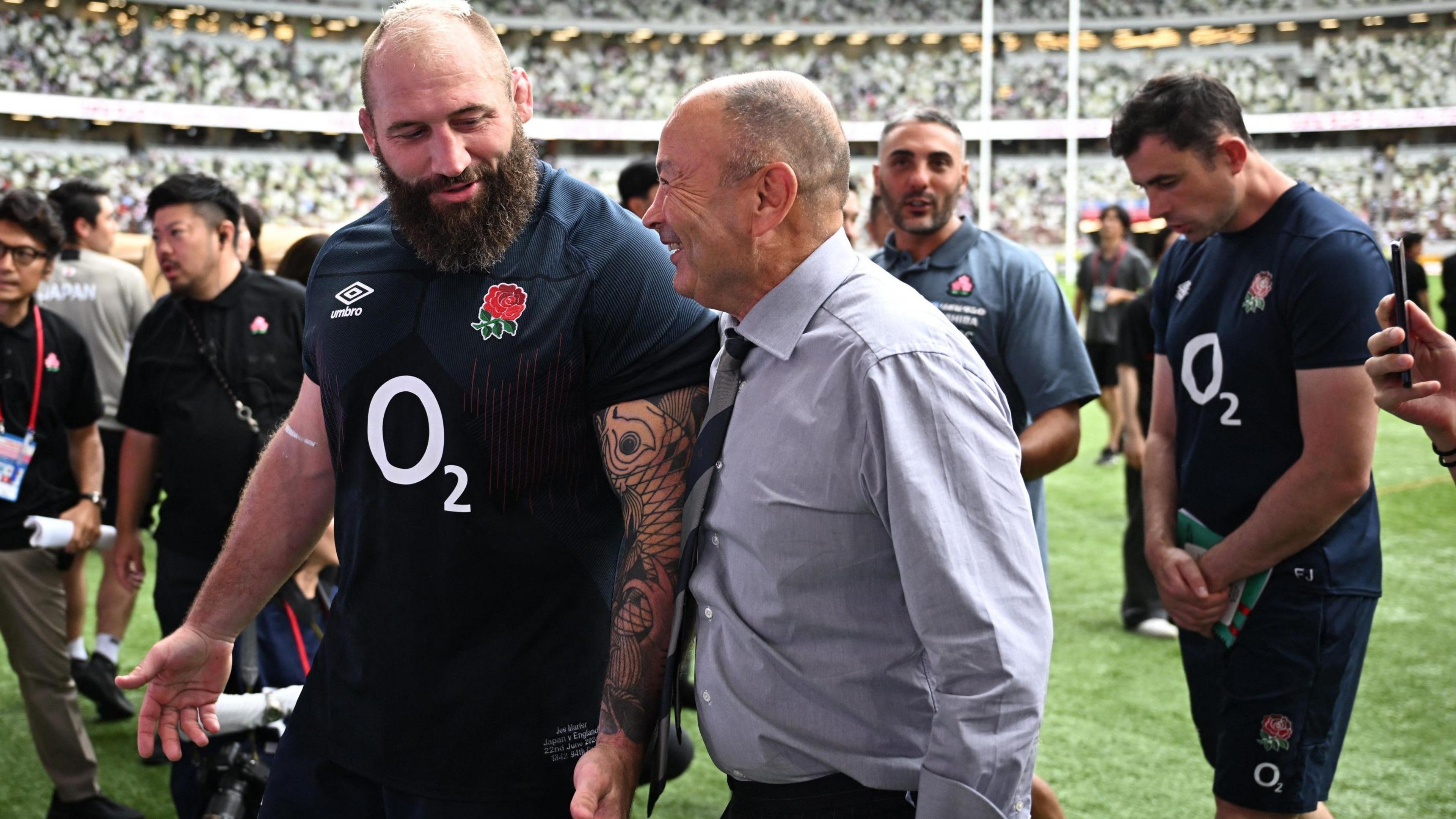 Joe Marler and Eddie Jones chat as they leave the pitch in Tokyo