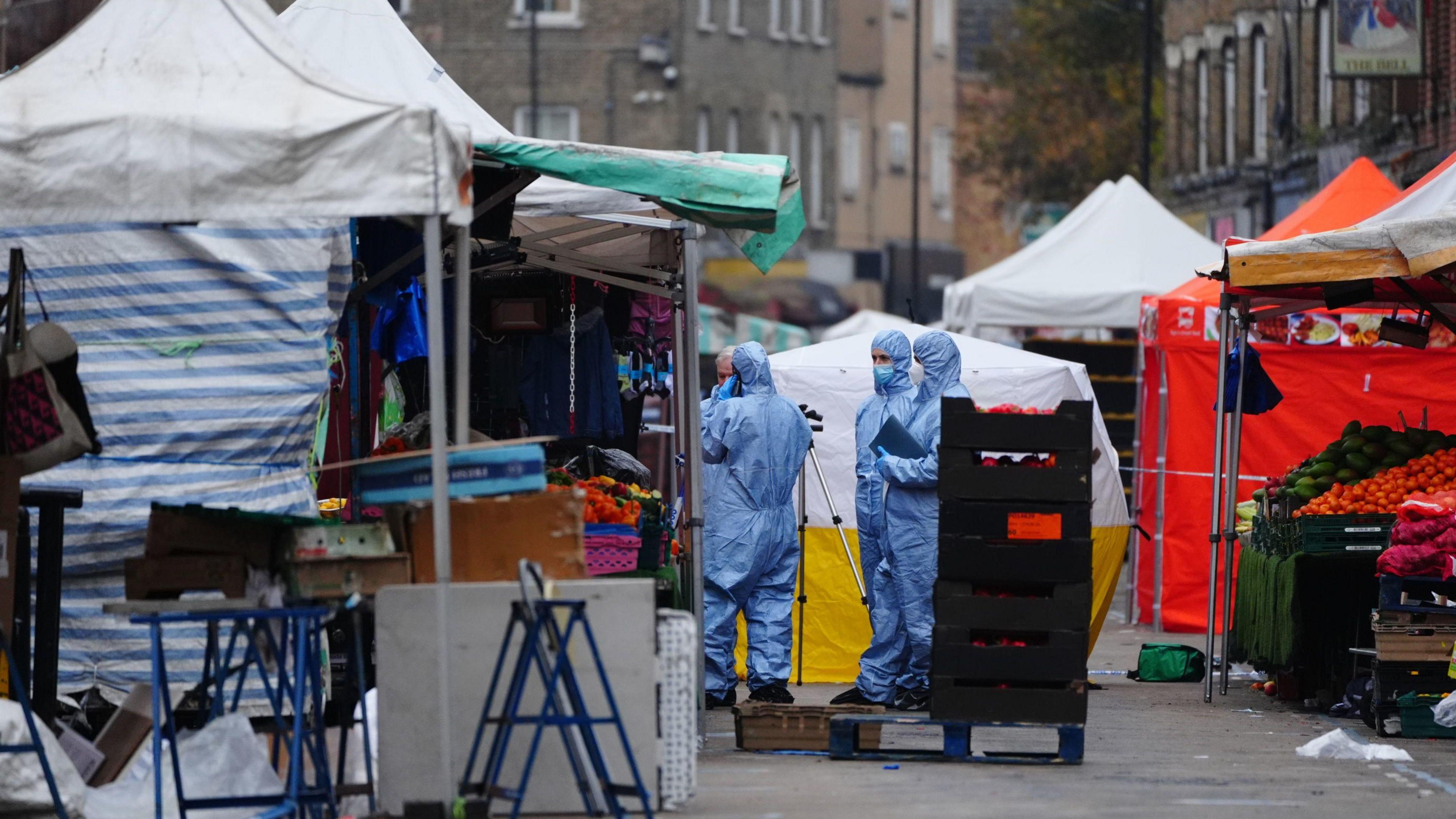 Forensic officers at the scene in East Street, Walworth