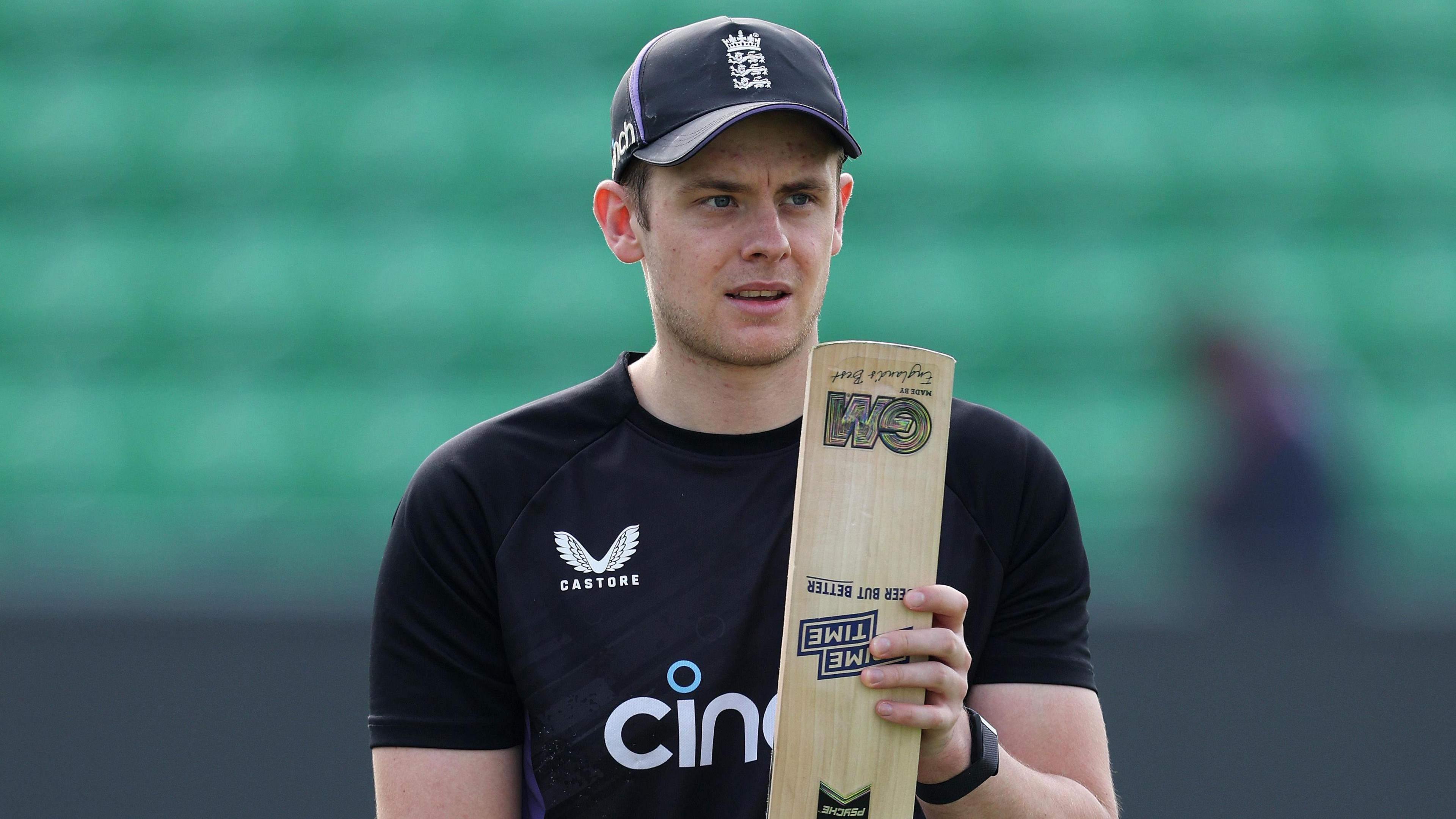 England wicketkeeper-batter Jamie Smith looks at the toe of his bat during training