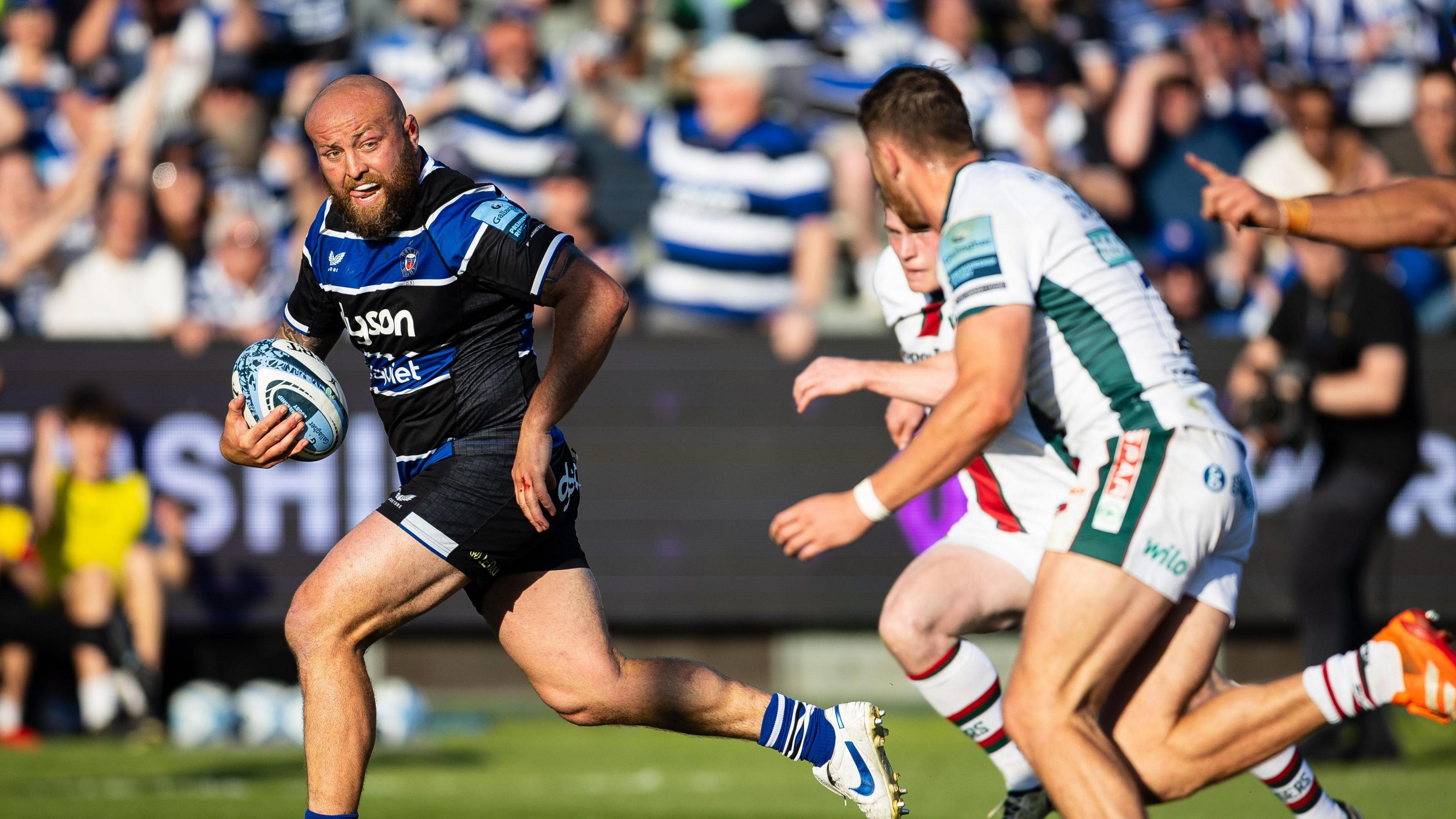 Tom Dunn (left) runs with the ball to score Bath's fourth try