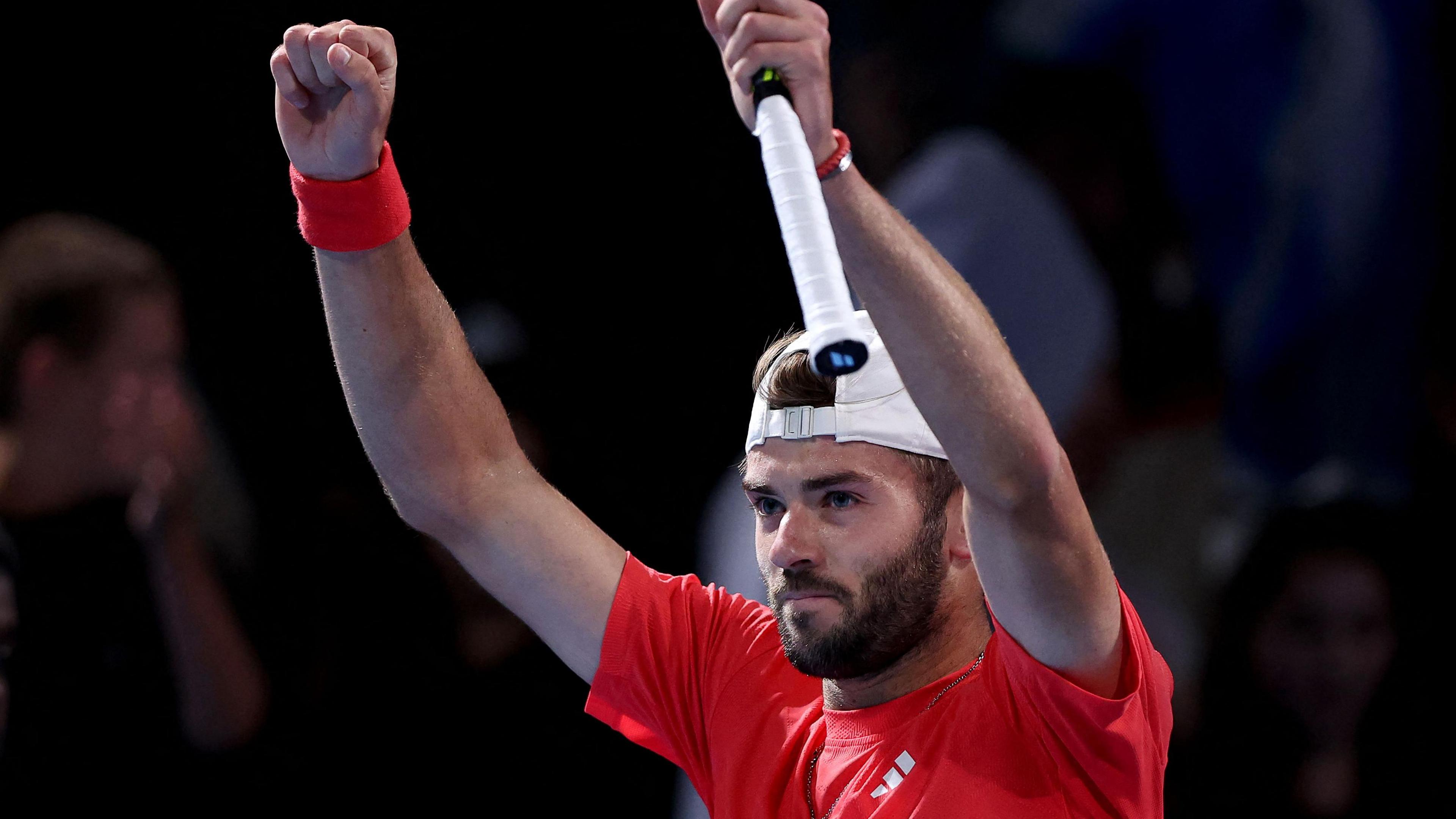 Jacob Fearnley holds his arms aloft after winning his Australian Open second-round match