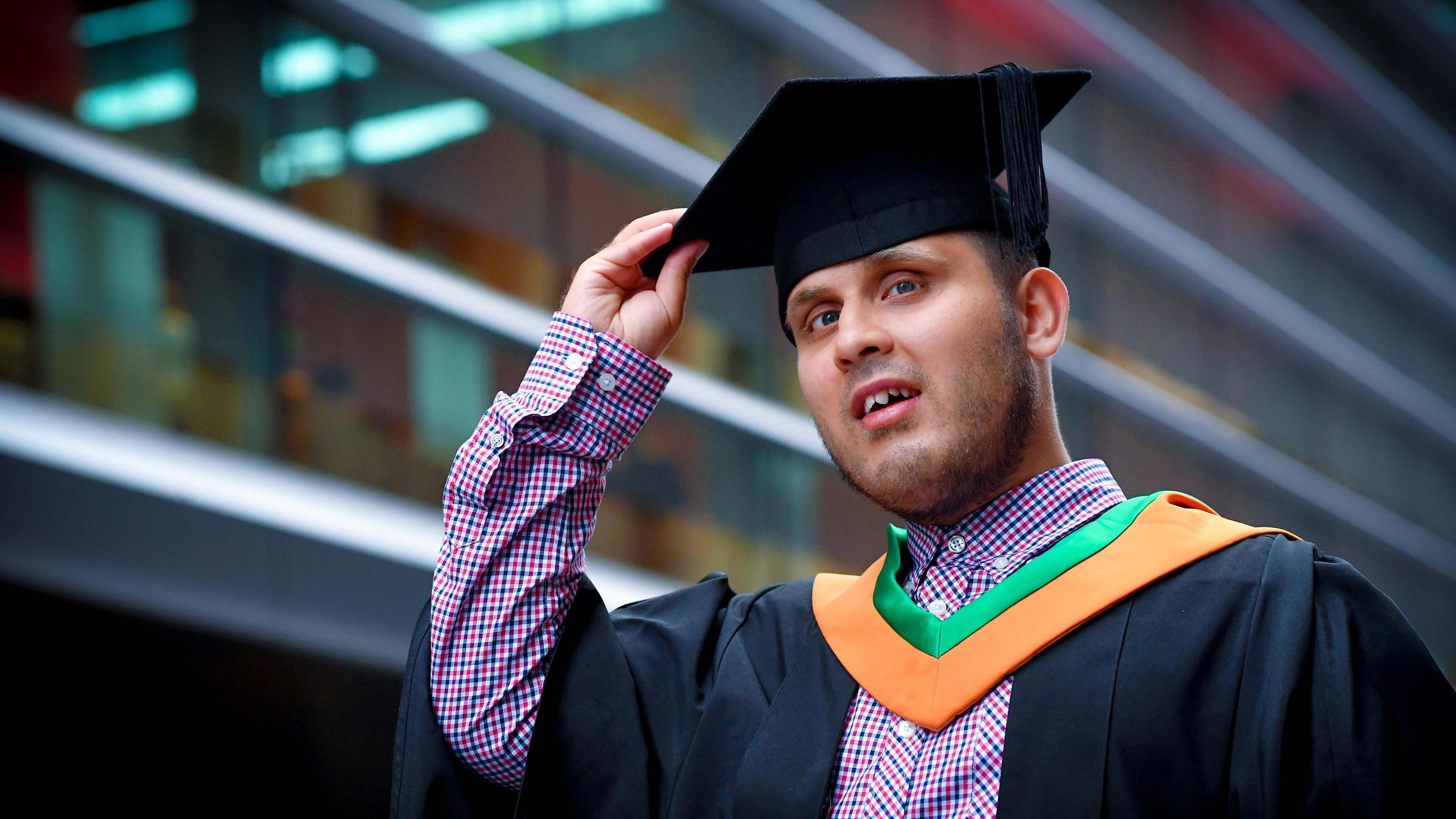 Haseeb Jabbar with a graduation gown and cap on