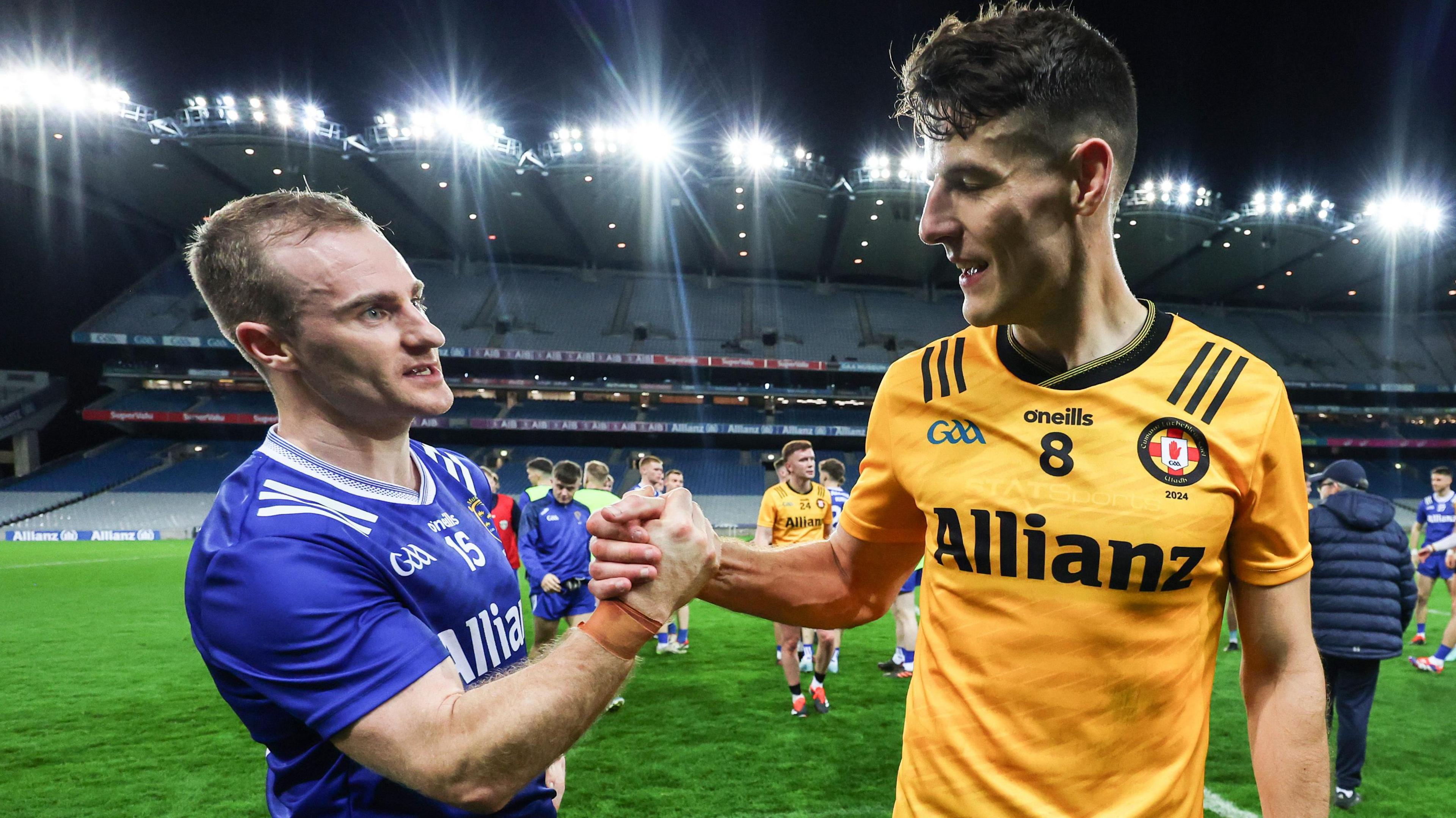 Ulster's Niall Grimley shakes hands with Munster's Mattie Taylor after the second Interprovincial Football semi-final at Croke Park