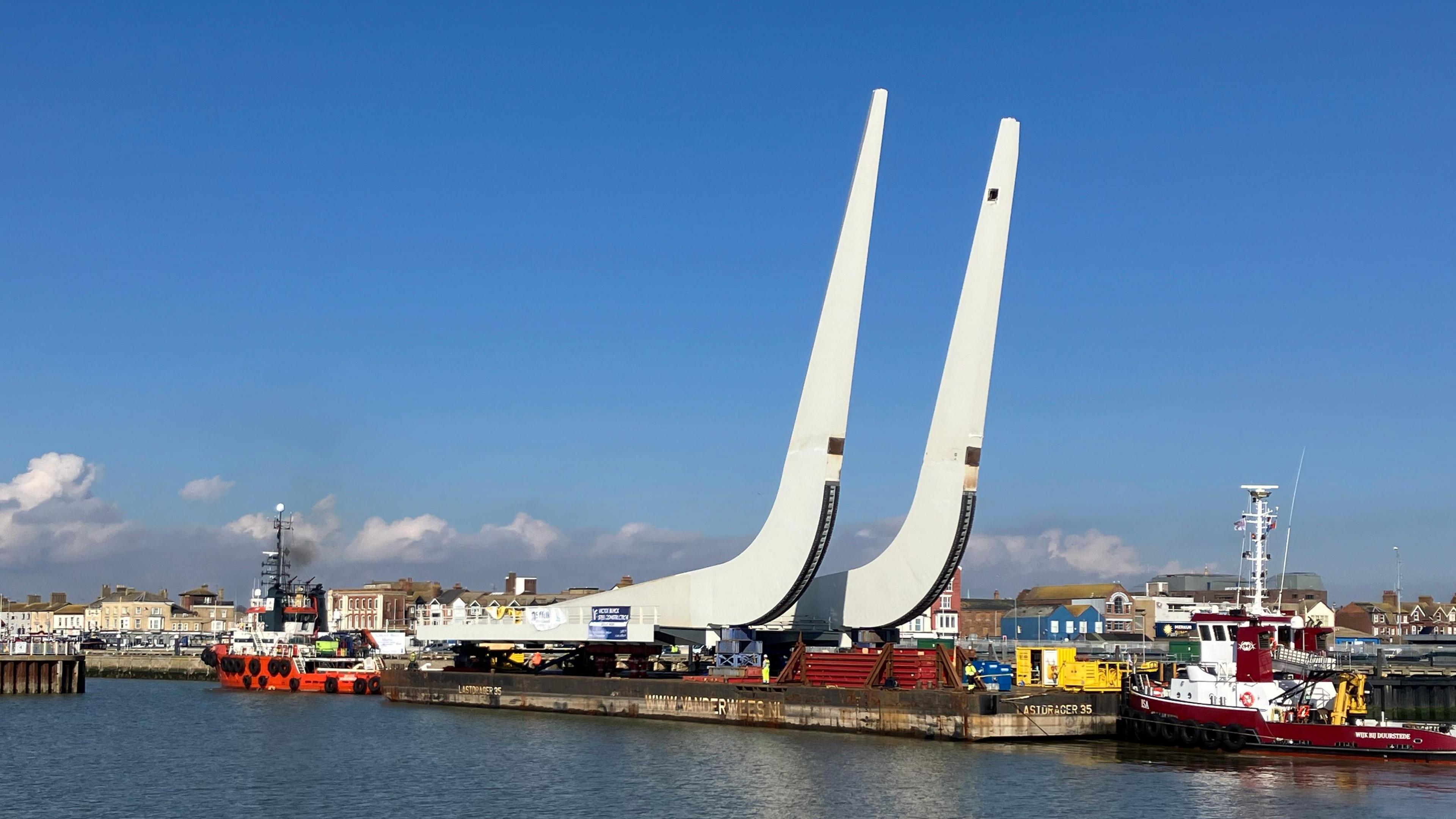 One of the white J-beams of the bascule span being shipped to the construction site of the Gull Wing Bridge in March, 2024