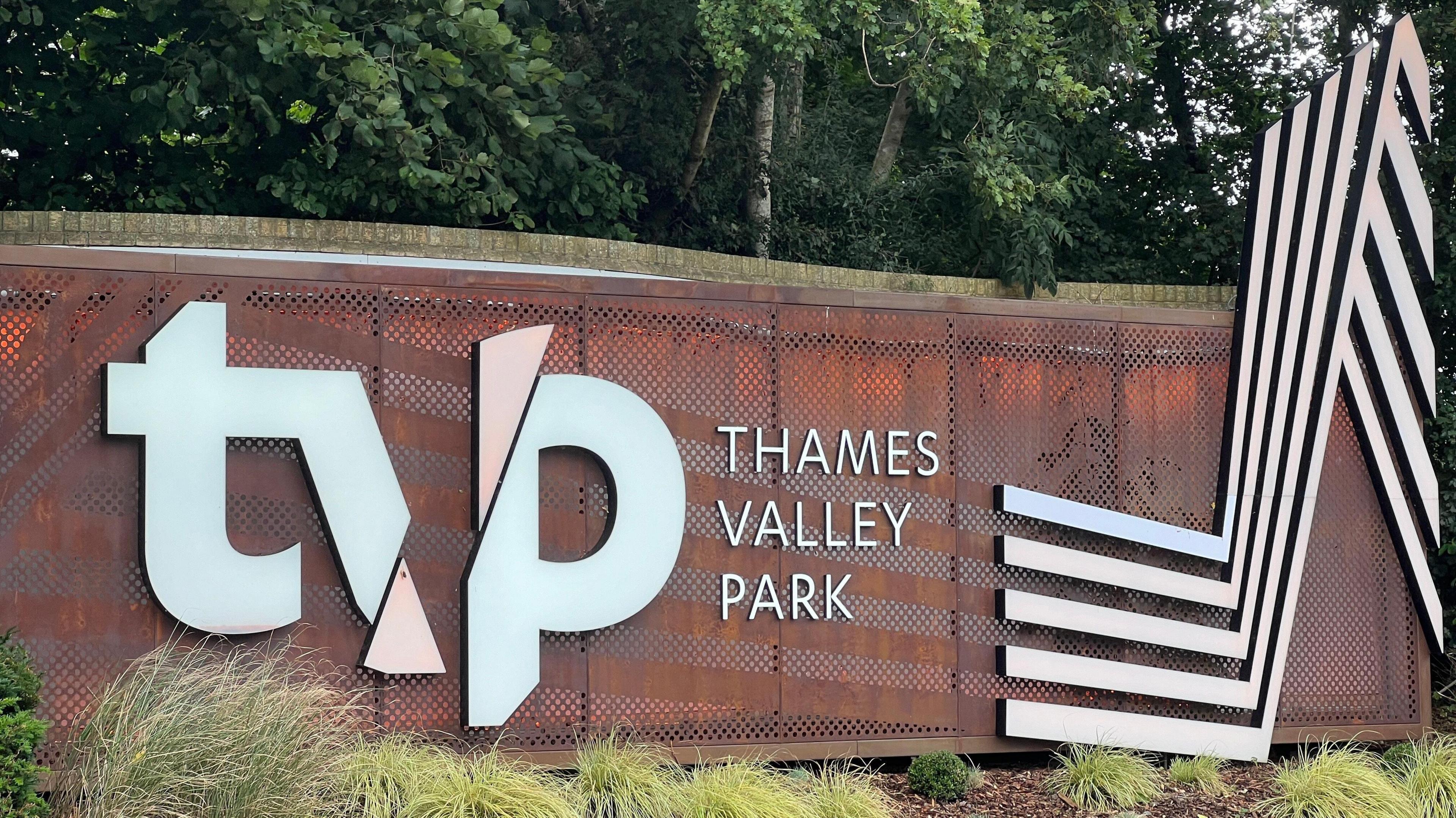 A large entrance sign saying Thames Valley Park. In the background there are trees.