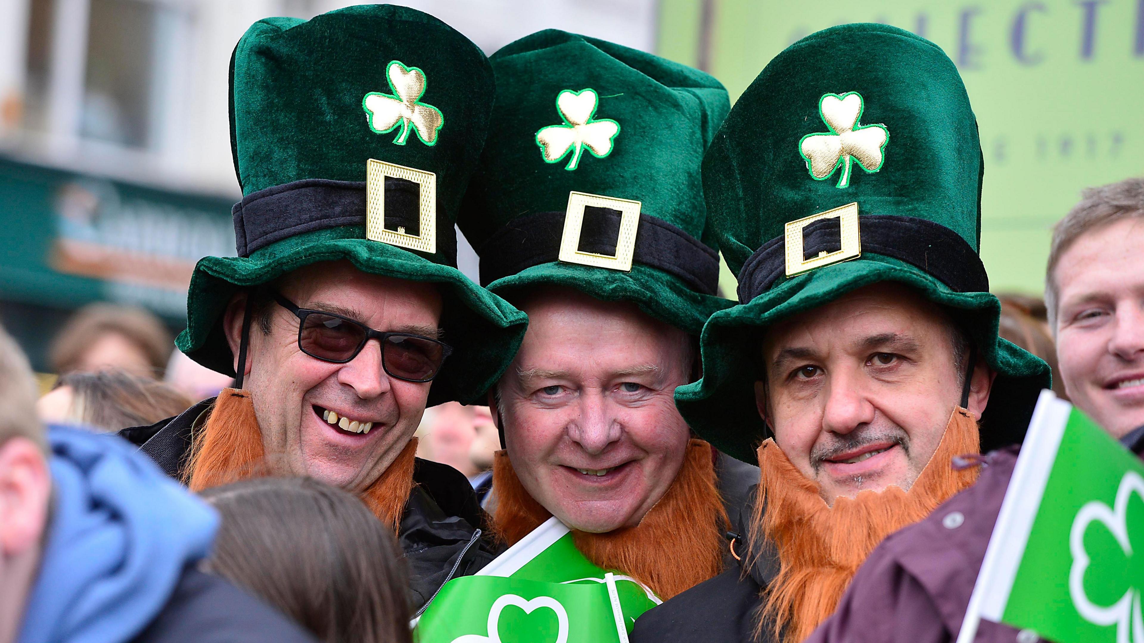 three men wearing leprechaun hats and fake ginger beards