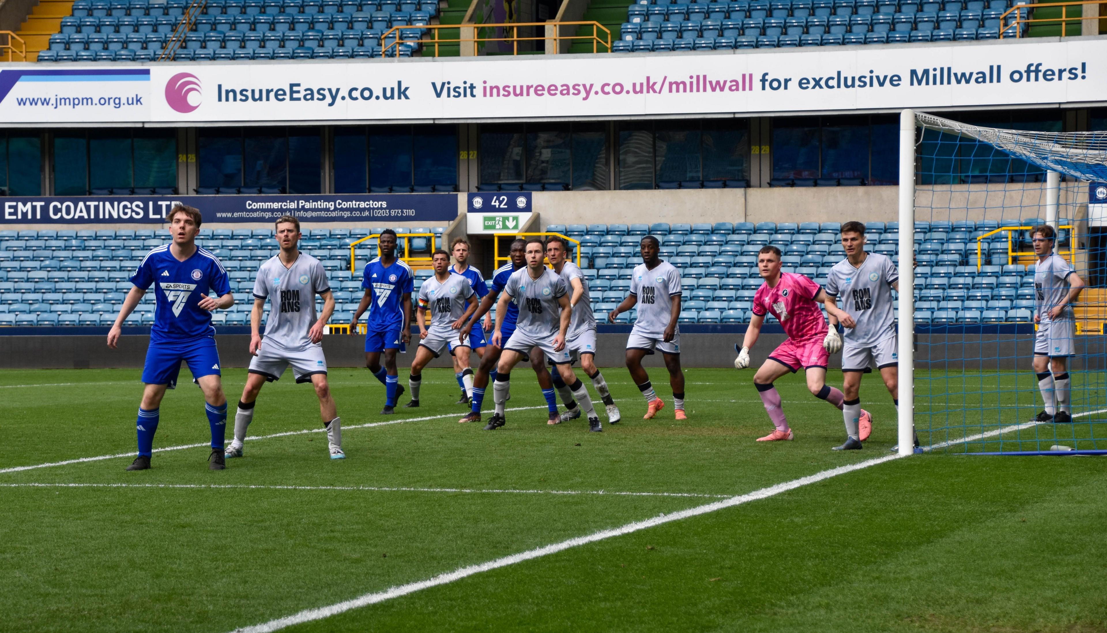 A group of football players on the pitch mid-game.
