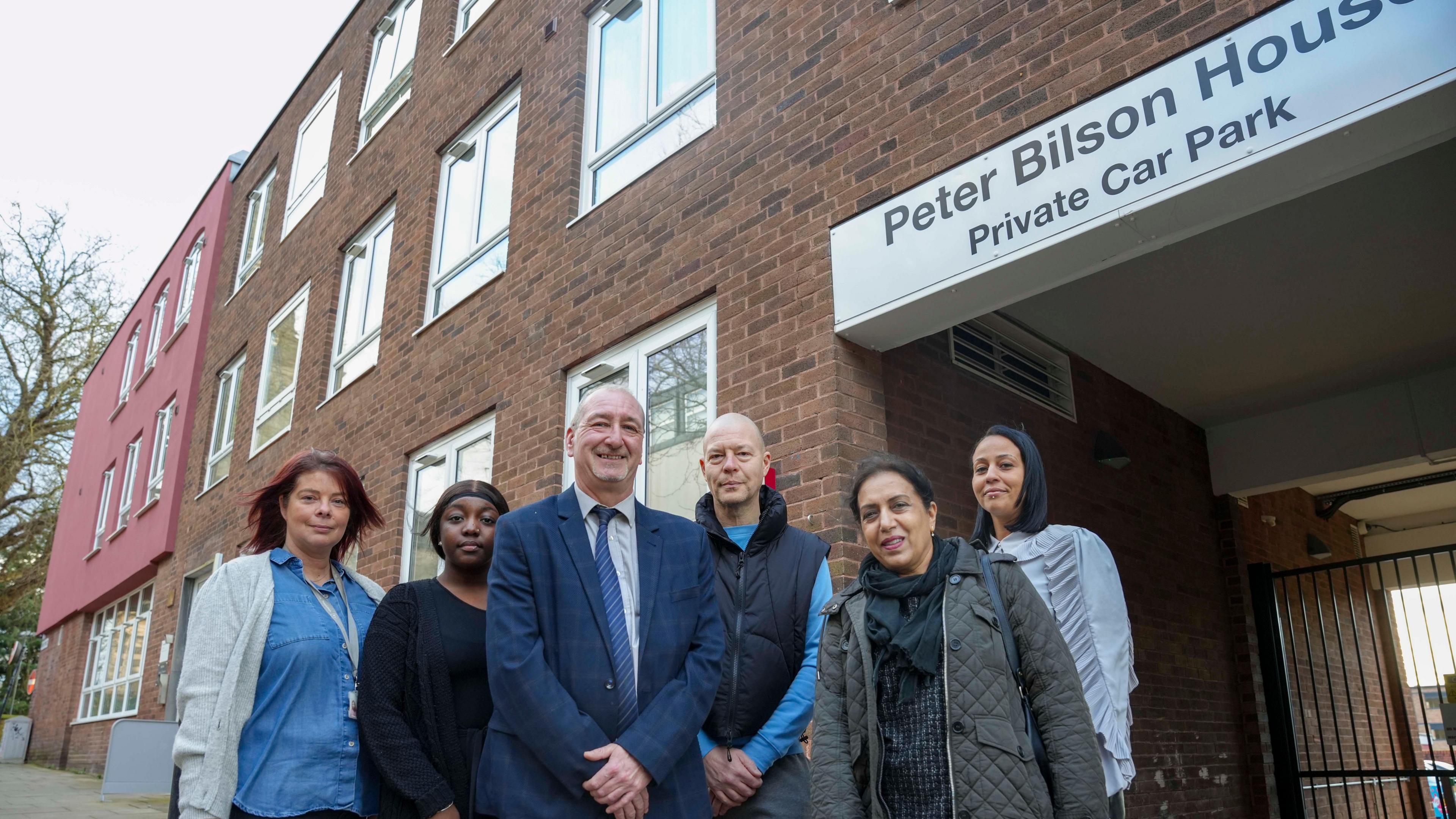 Left to right: P3 Support Workers Tara Smith and Tajah Wright, Councillor Steve Evans, Deputy Leader and Cabinet Member for Housing at City of Wolverhampton Council, Peter Bilson House resident Leeroy Haynes, Councillor Jasbir Jaspal, Cabinet Member for Adults and Wellbeing at City of Wolverhampton Council and Peter Bilson House Manager at P3 Stephanie Holland, outside Peter Bilson House.