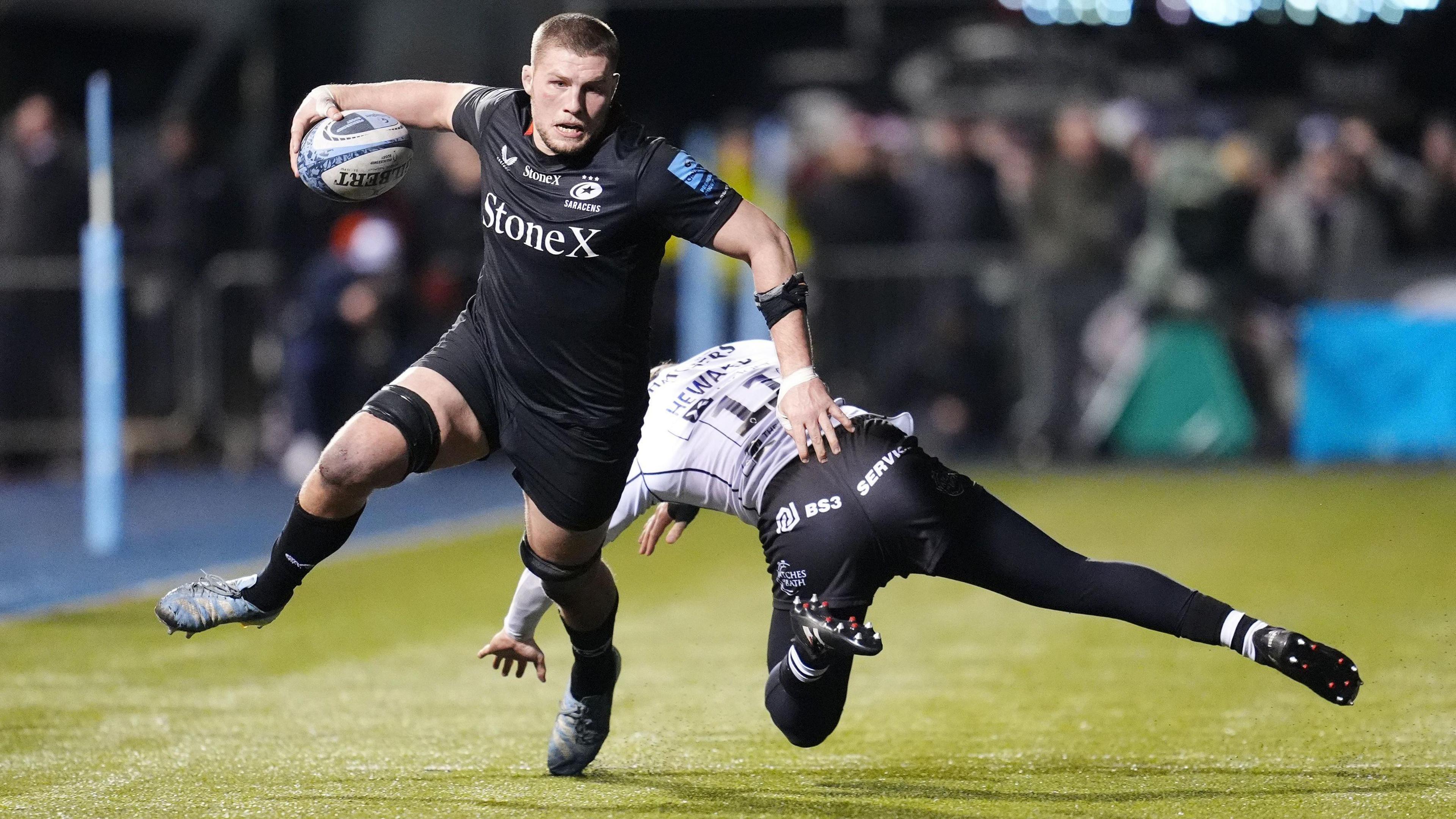 Tom Willis runs past a tackler to score a try