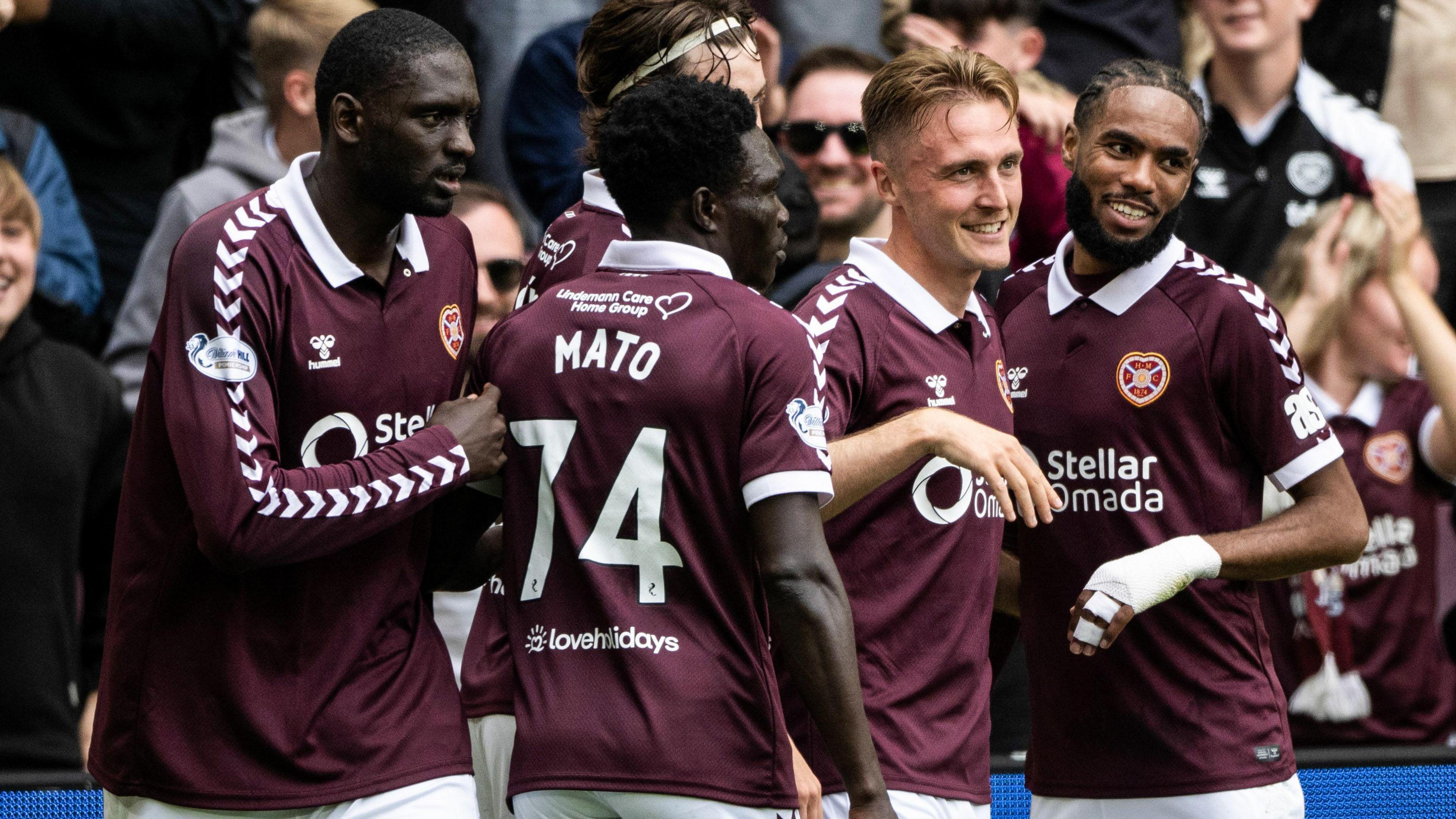 Christian Borchgrevink is mobbed by his Hearts team-mates