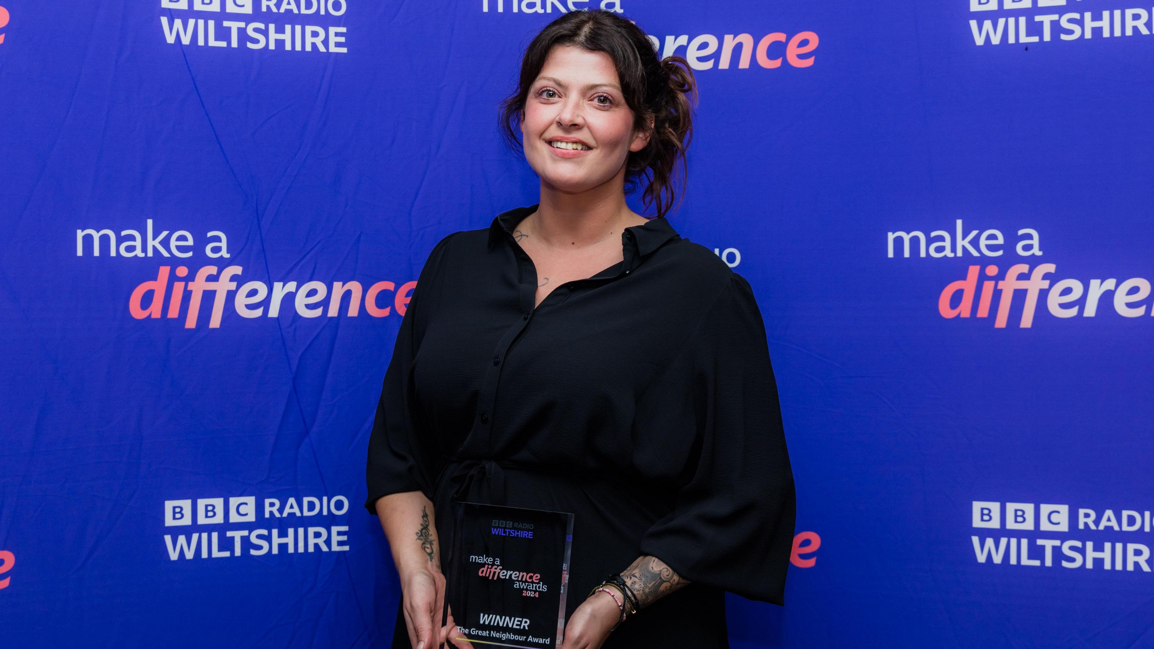 Hannah Coates in front of the BBC Radio Wiltshire purple banner