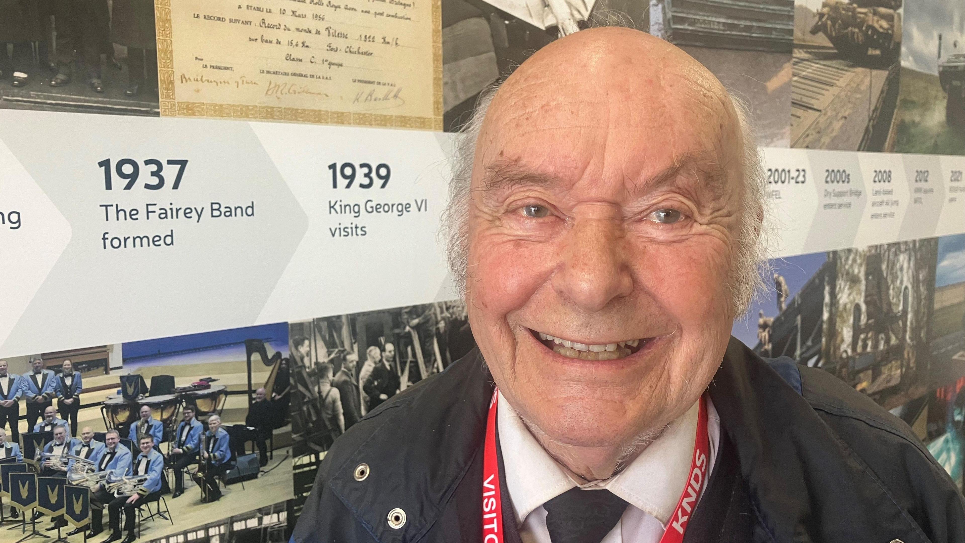 Photograph of the former munitions worker Roy Clarke. The picture is taken at the former Fairey Aviation factory at Heaton Chapel.