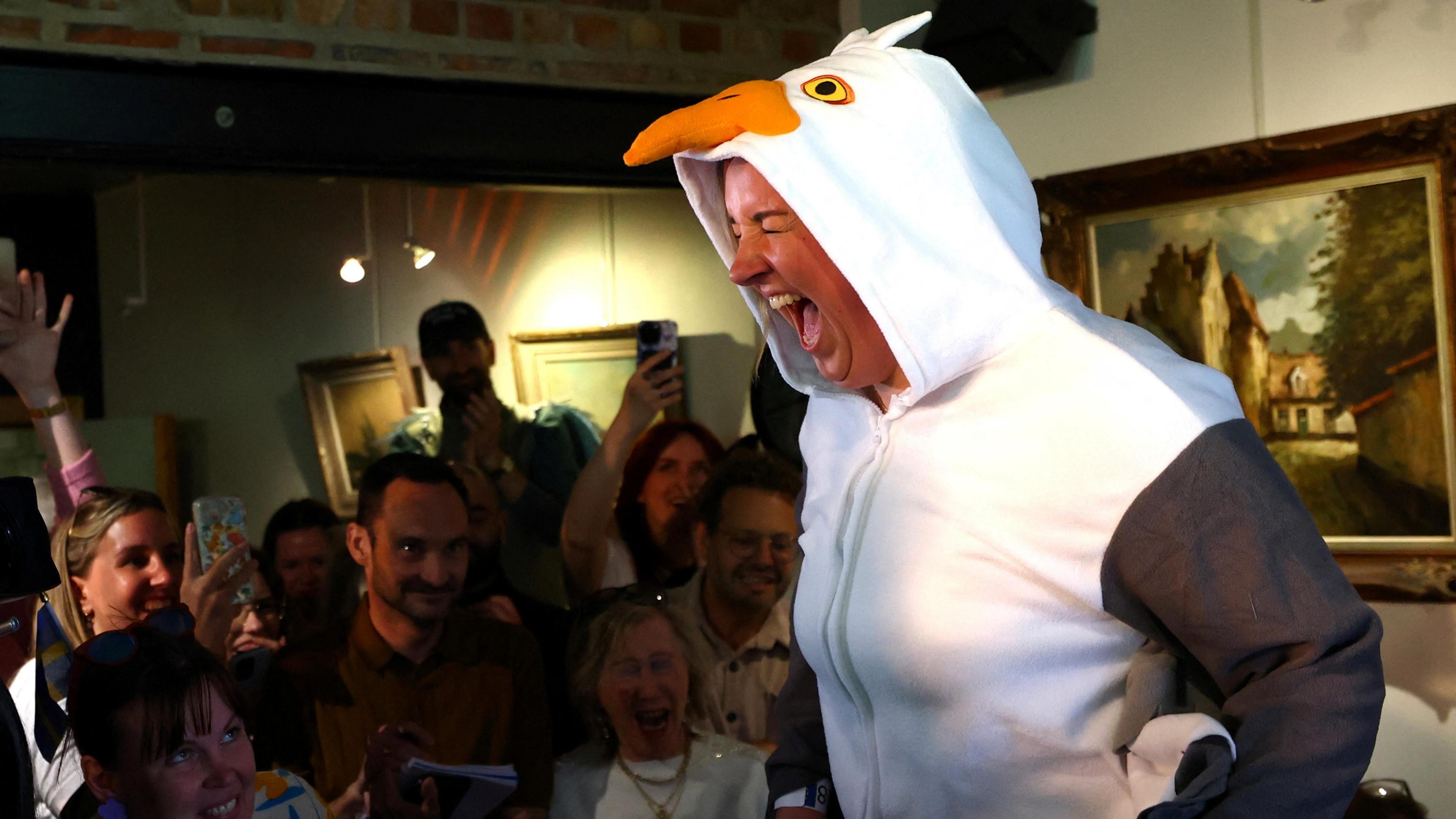A competitor takes part in the sixth edition of the European seagull screeching championship, wearing a seagull onesie.