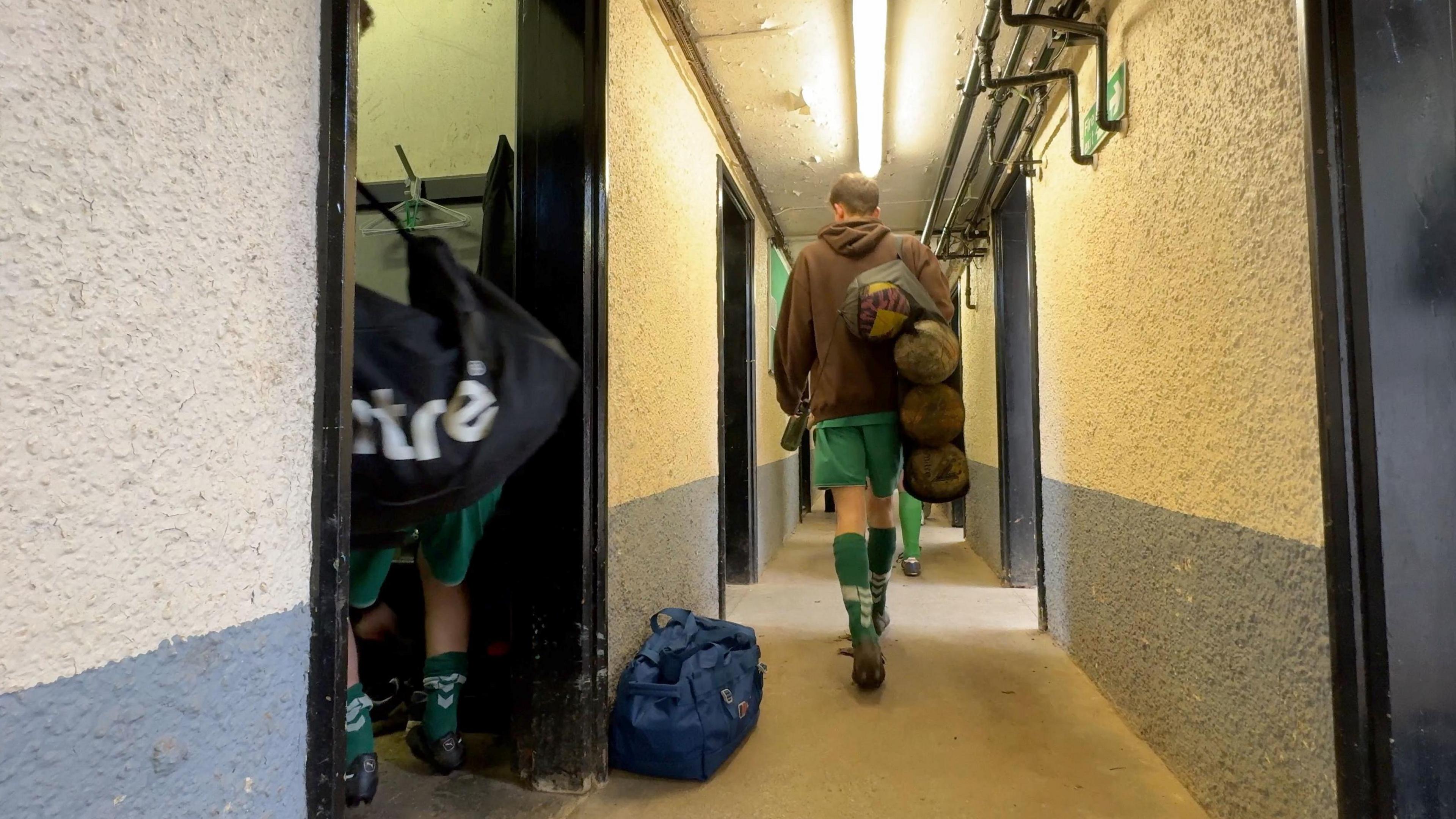 Players walk through the corridor of the changing rooms