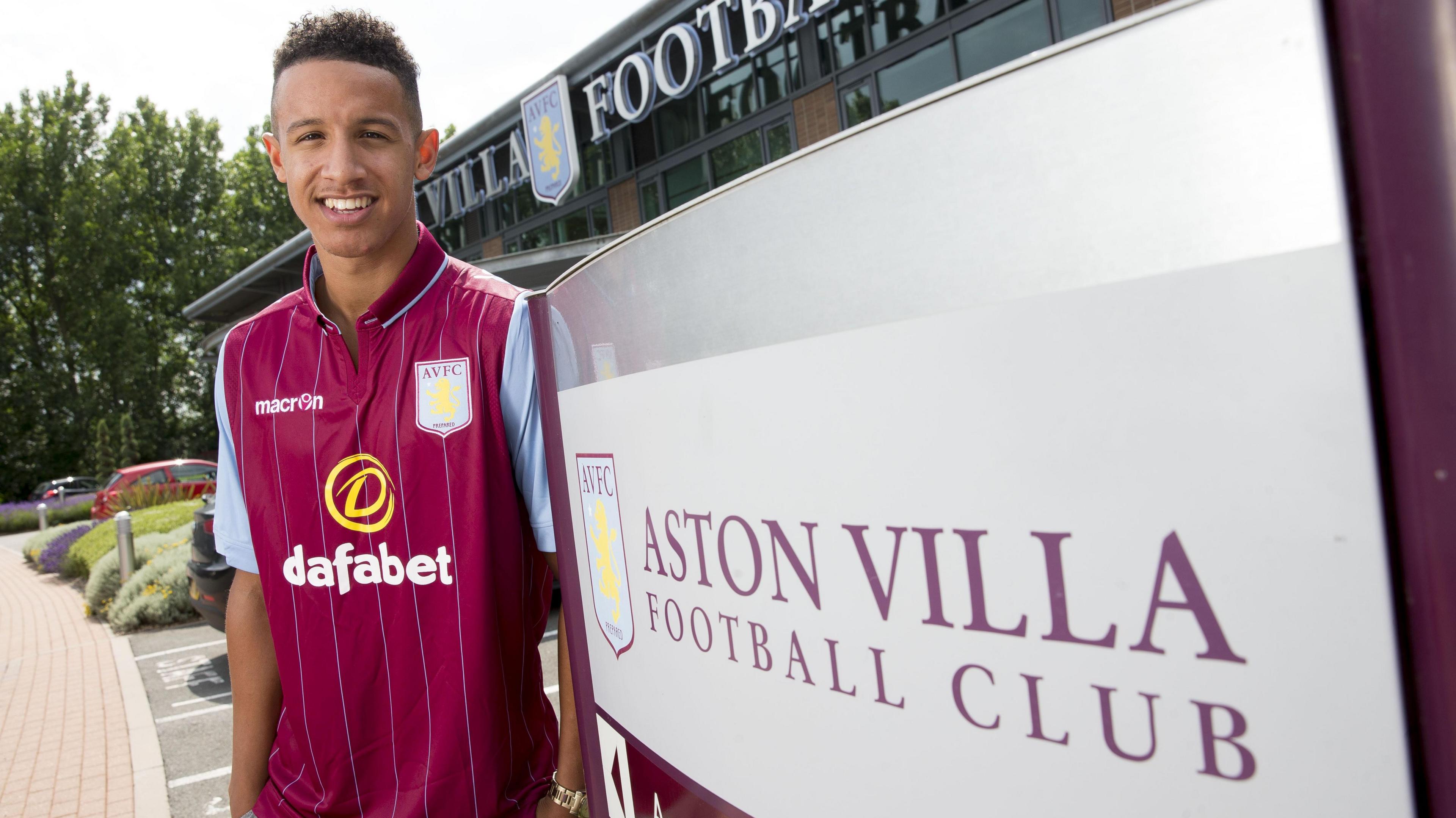 Callum Robinson posing in Aston Villa kit at their training ground