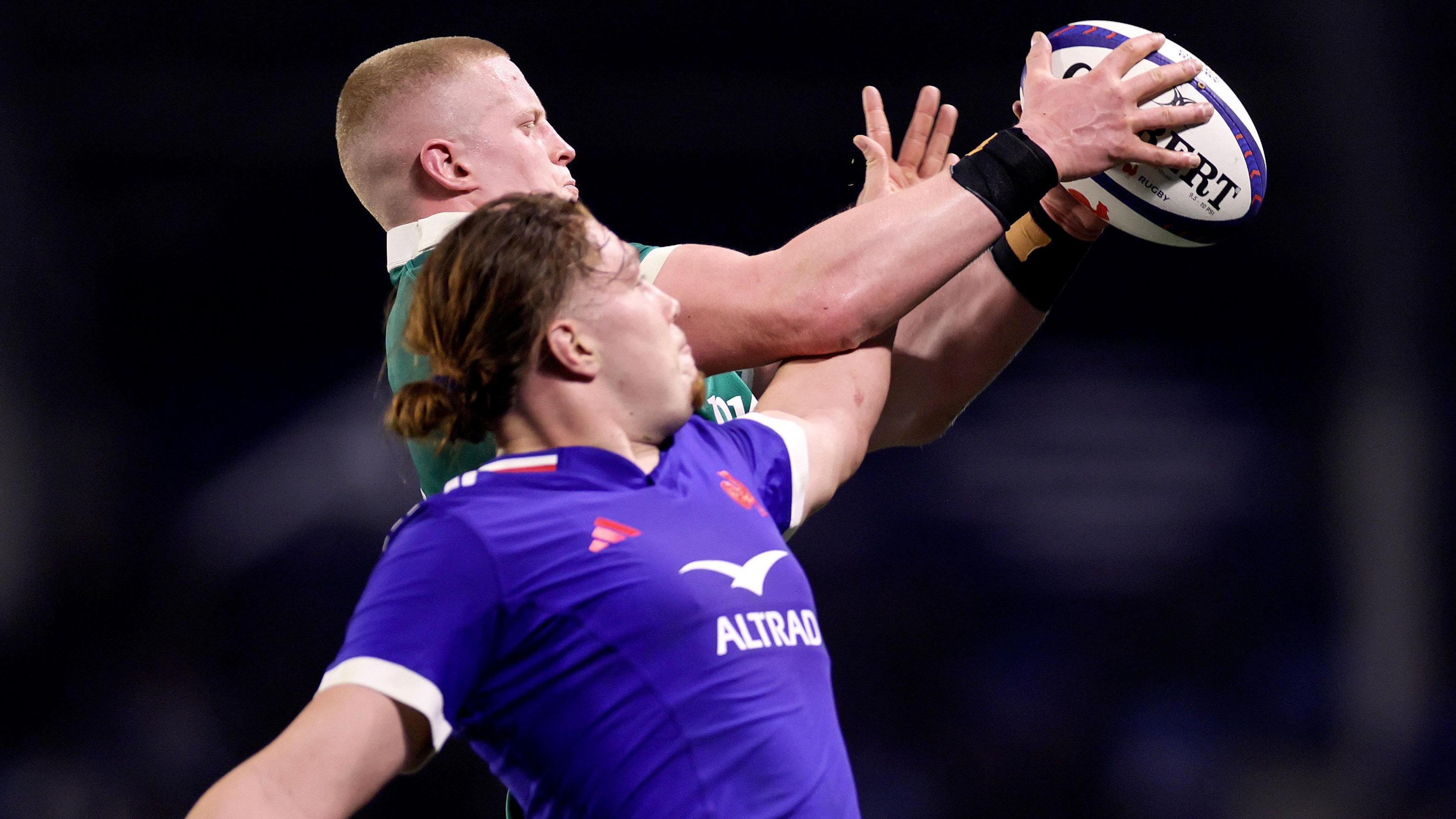 Dylan McNeice and Nils Punti challenge for the ball