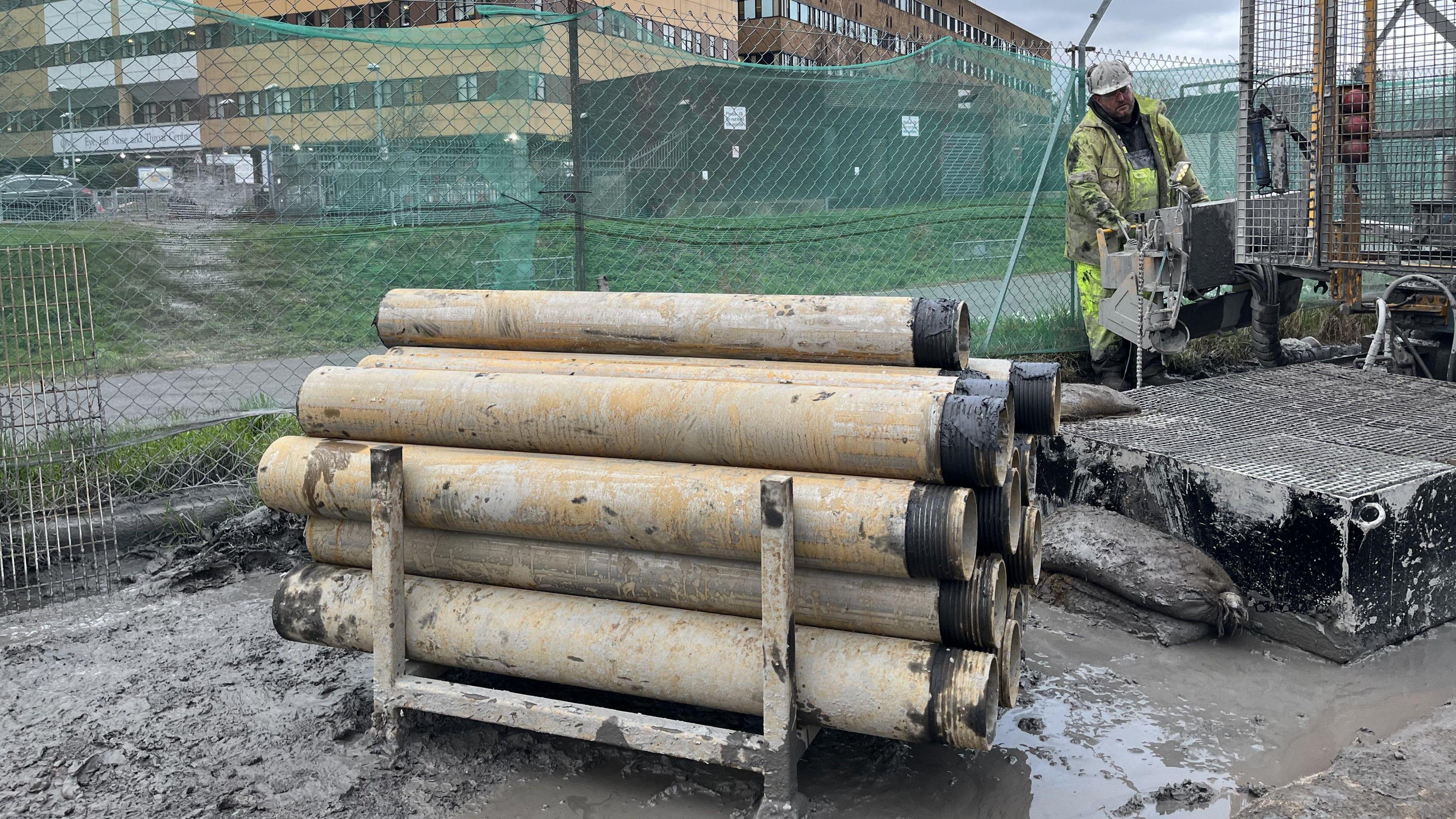 Pipes beside a borehole drill