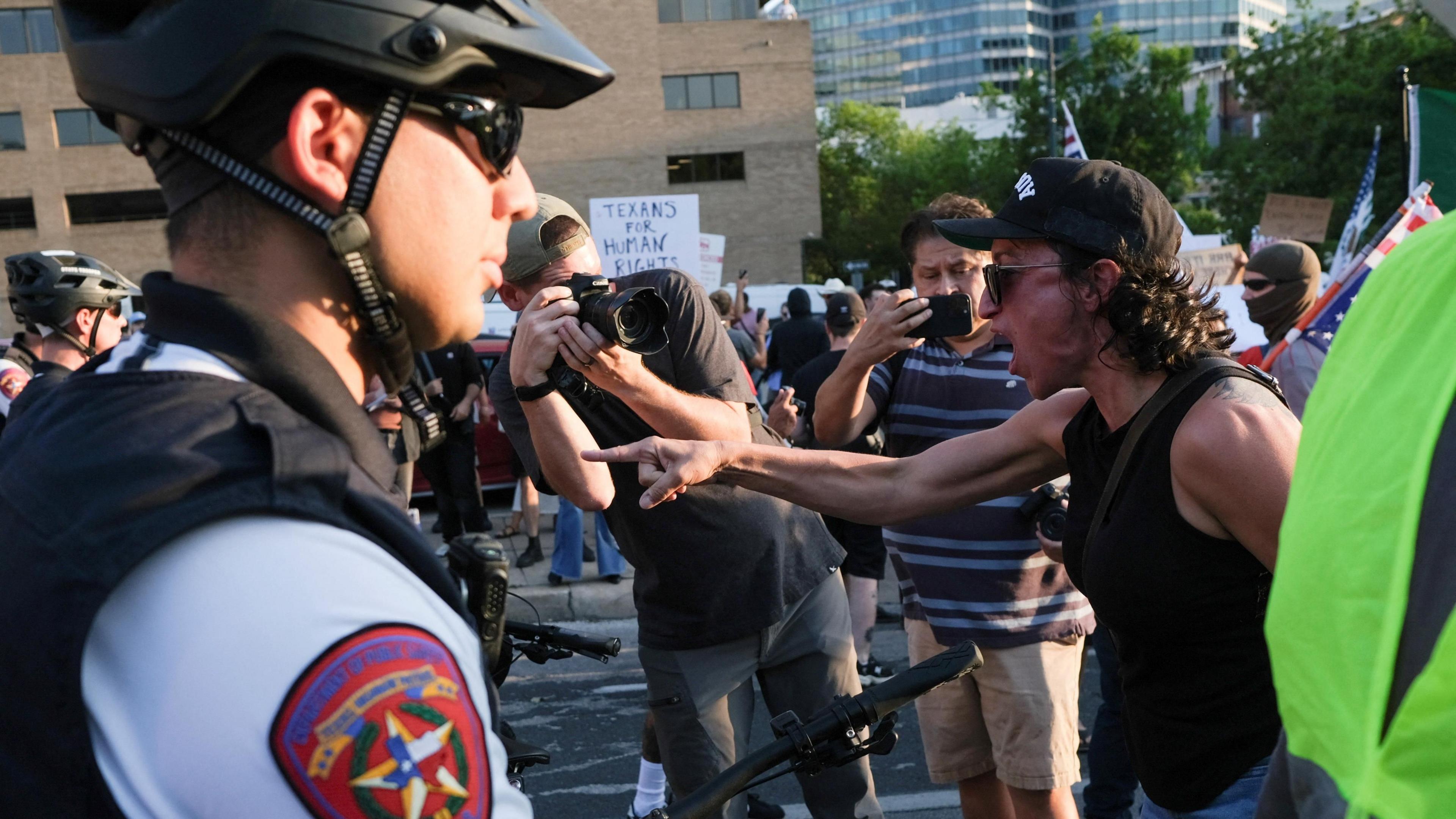 A man points and shouts at a line of armed police during a protest in Austin, Texas, on 10 June 2025