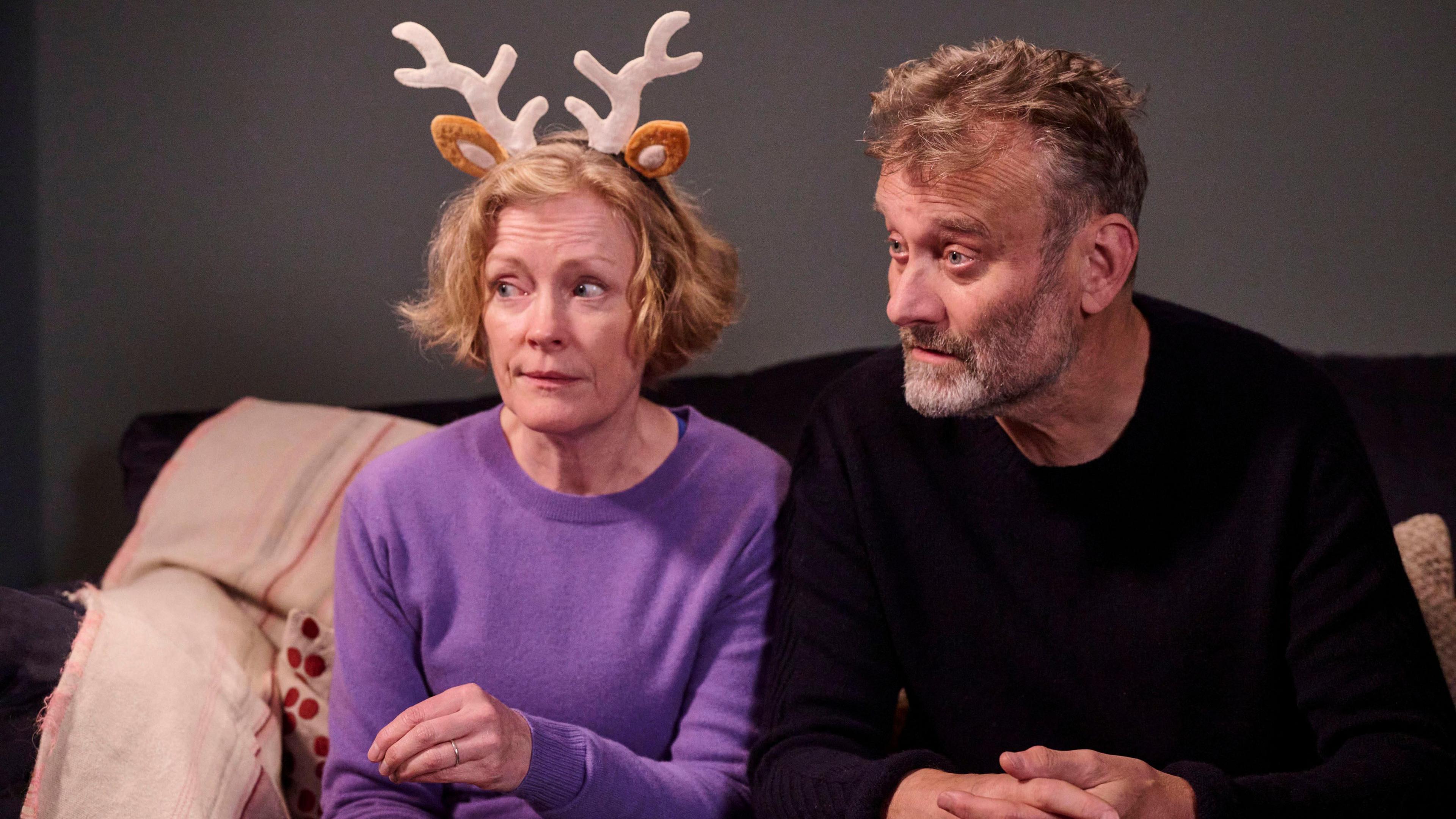 Right to left: Claire Skinner wearing reindeer antlers, and Hugh Dennis