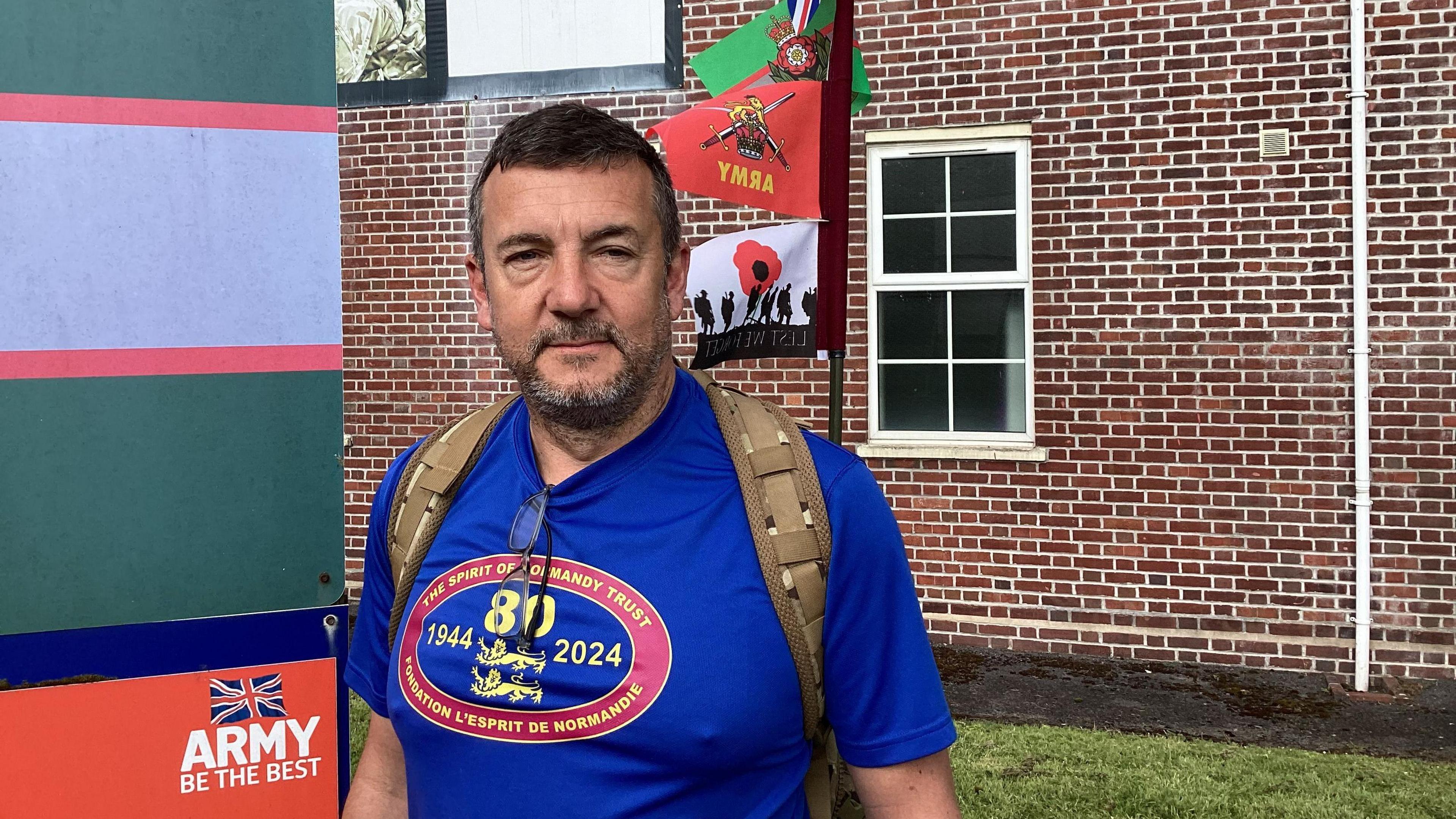 Dave Westall standing in front of barracks