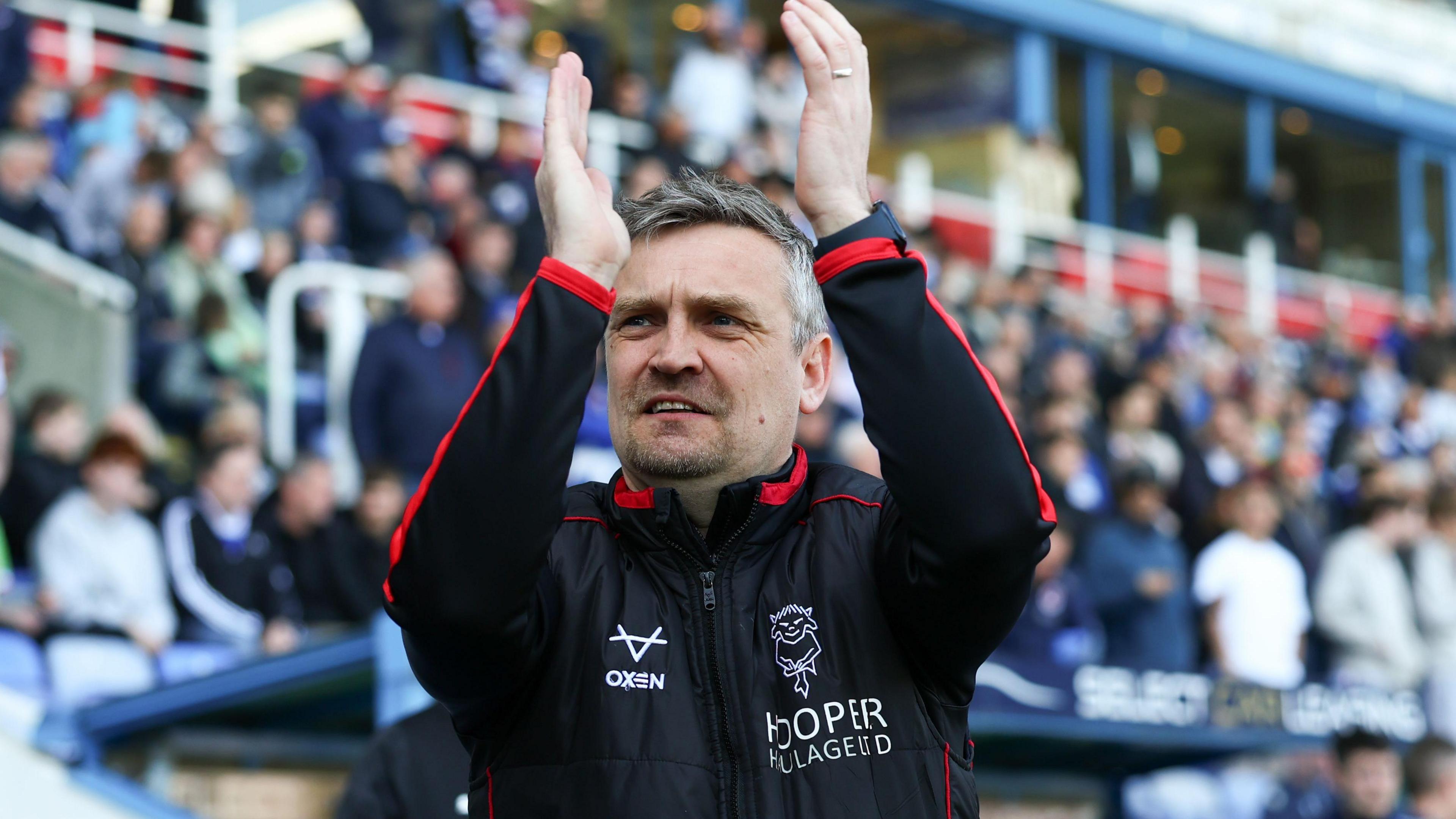 Lincoln boss Michael Skubala claps the travelling fans at Reading