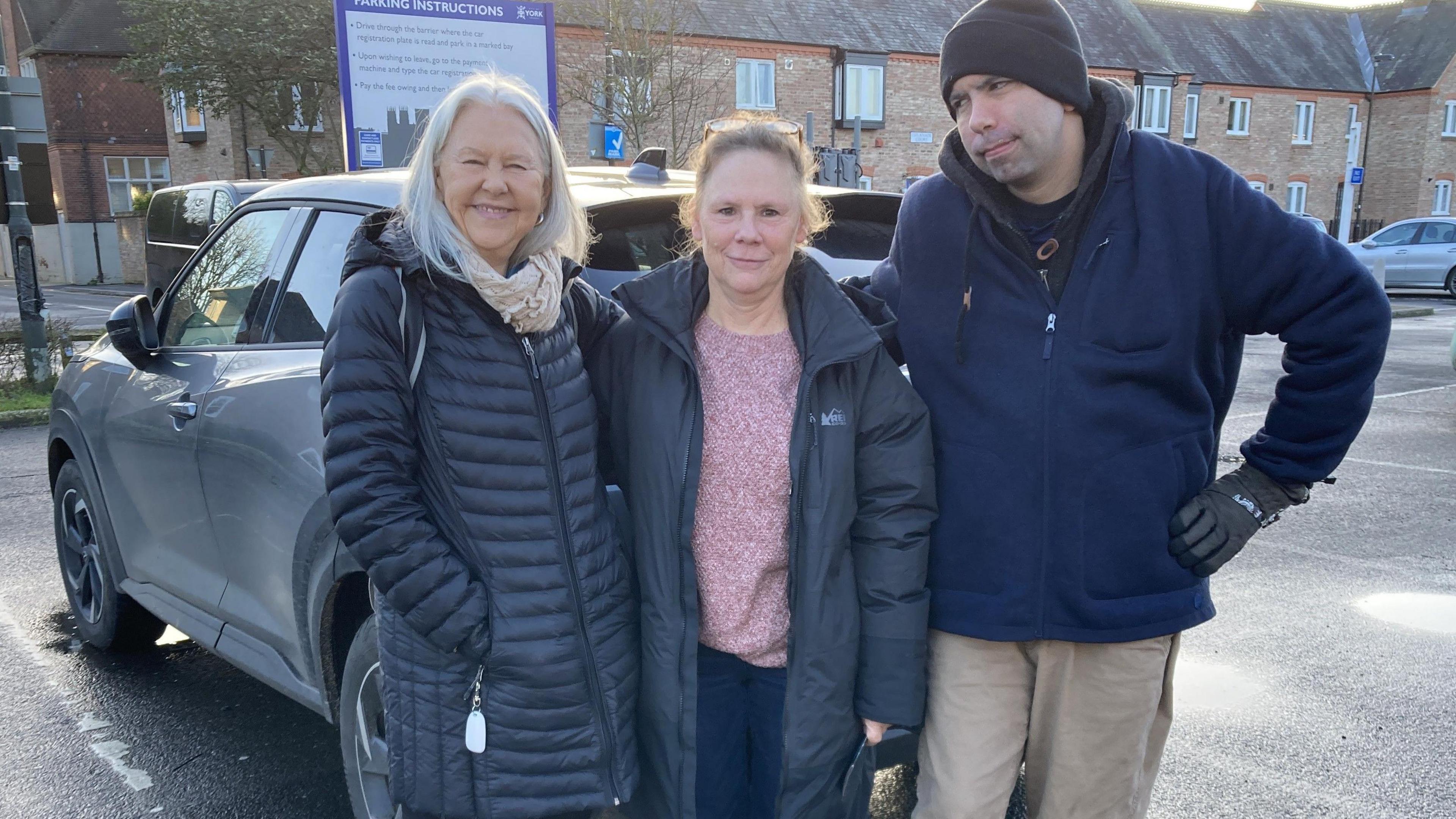 Barbara, Barbara and David in front of car